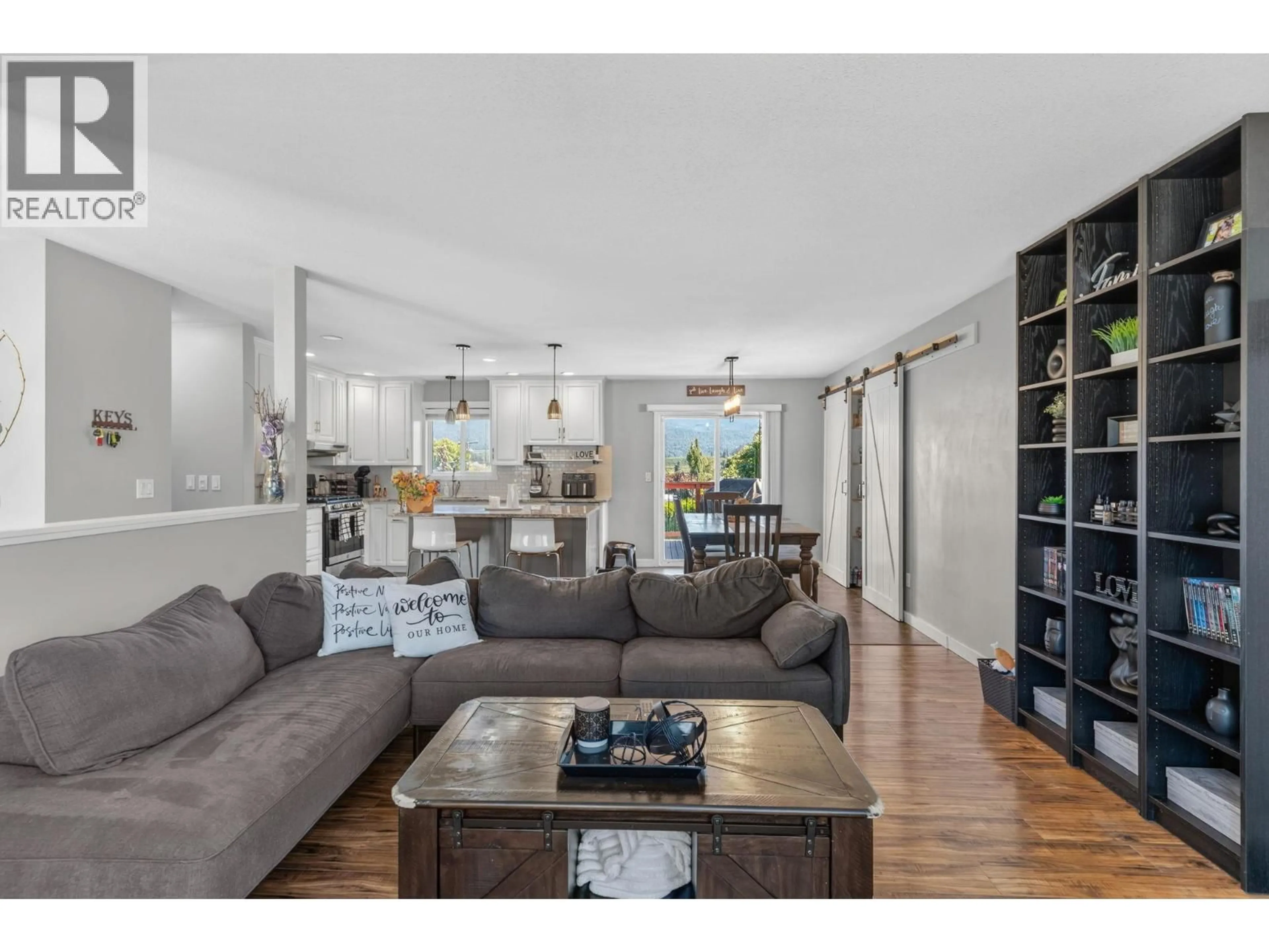 Living room with furniture, wood/laminate floor for 1863 CATHY AVENUE, Kelowna British Columbia V1P1L4