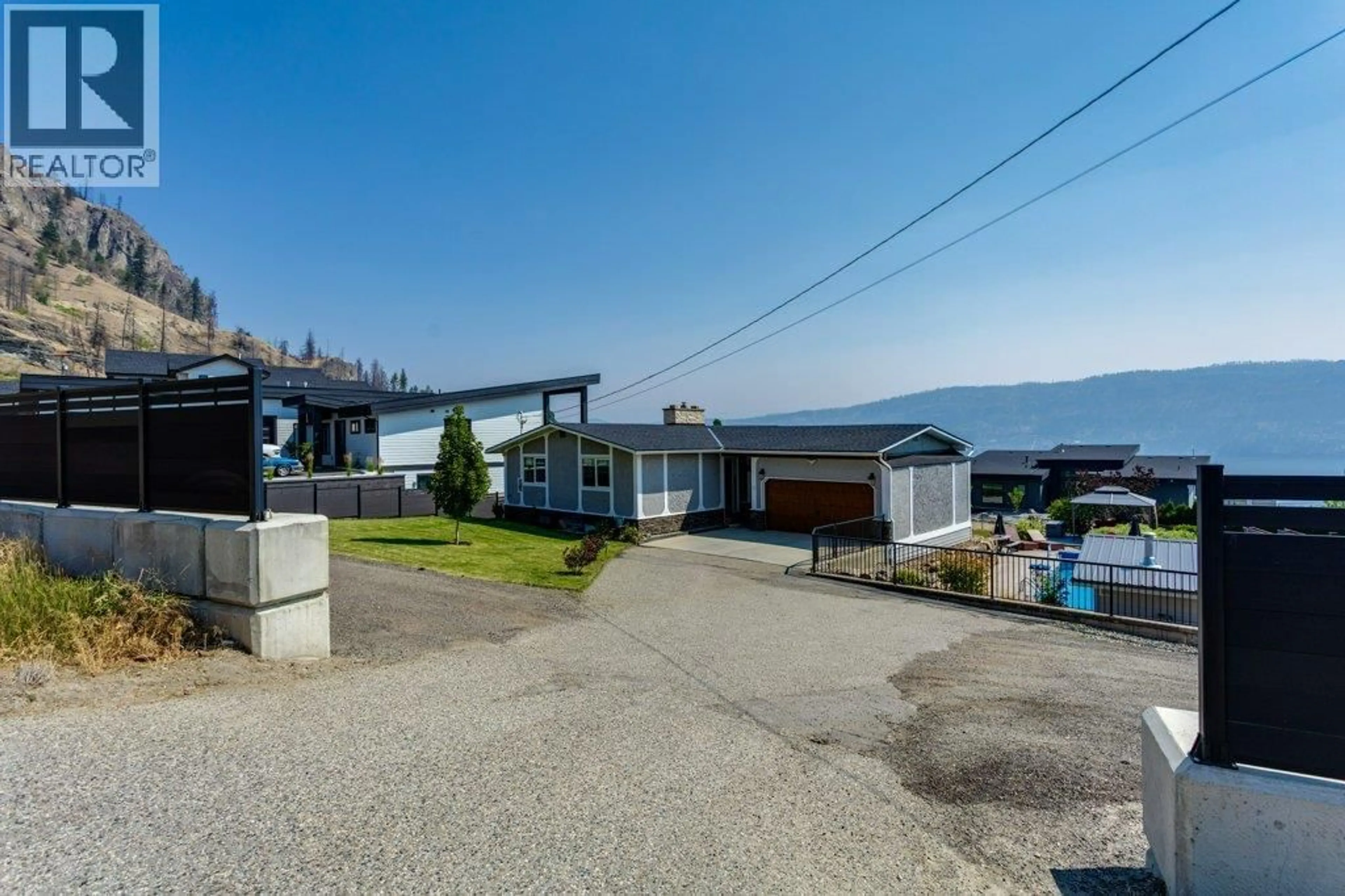 A pic from outside/outdoor area/front of a property/back of a property/a pic from drone, street for 111 WESTSIDE ROAD NORTH, Kelowna British Columbia V1Z3S4