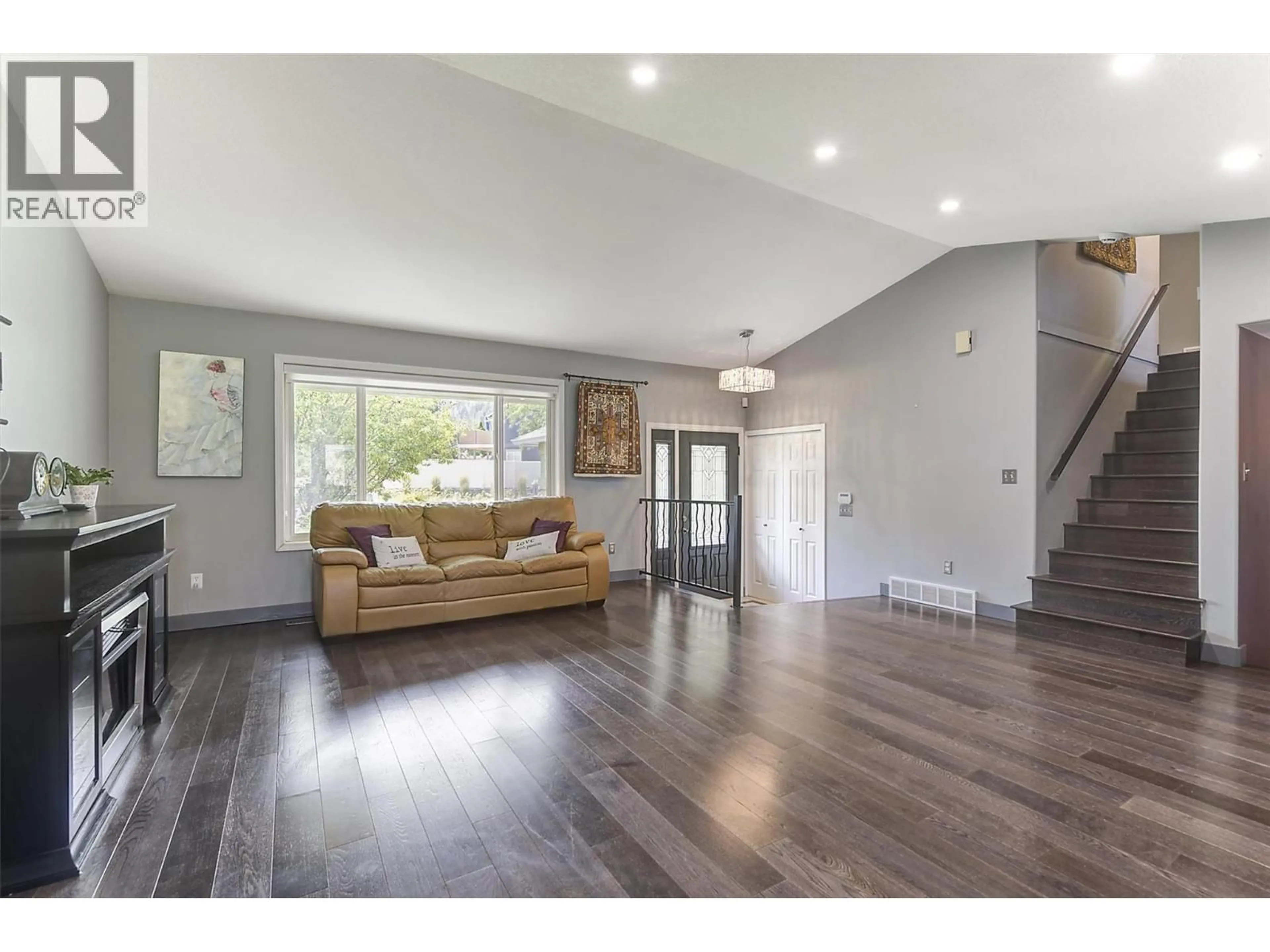 Living room with furniture, wood/laminate floor for 1852 CROSSGLEN COURT, Kelowna British Columbia V1V1S4