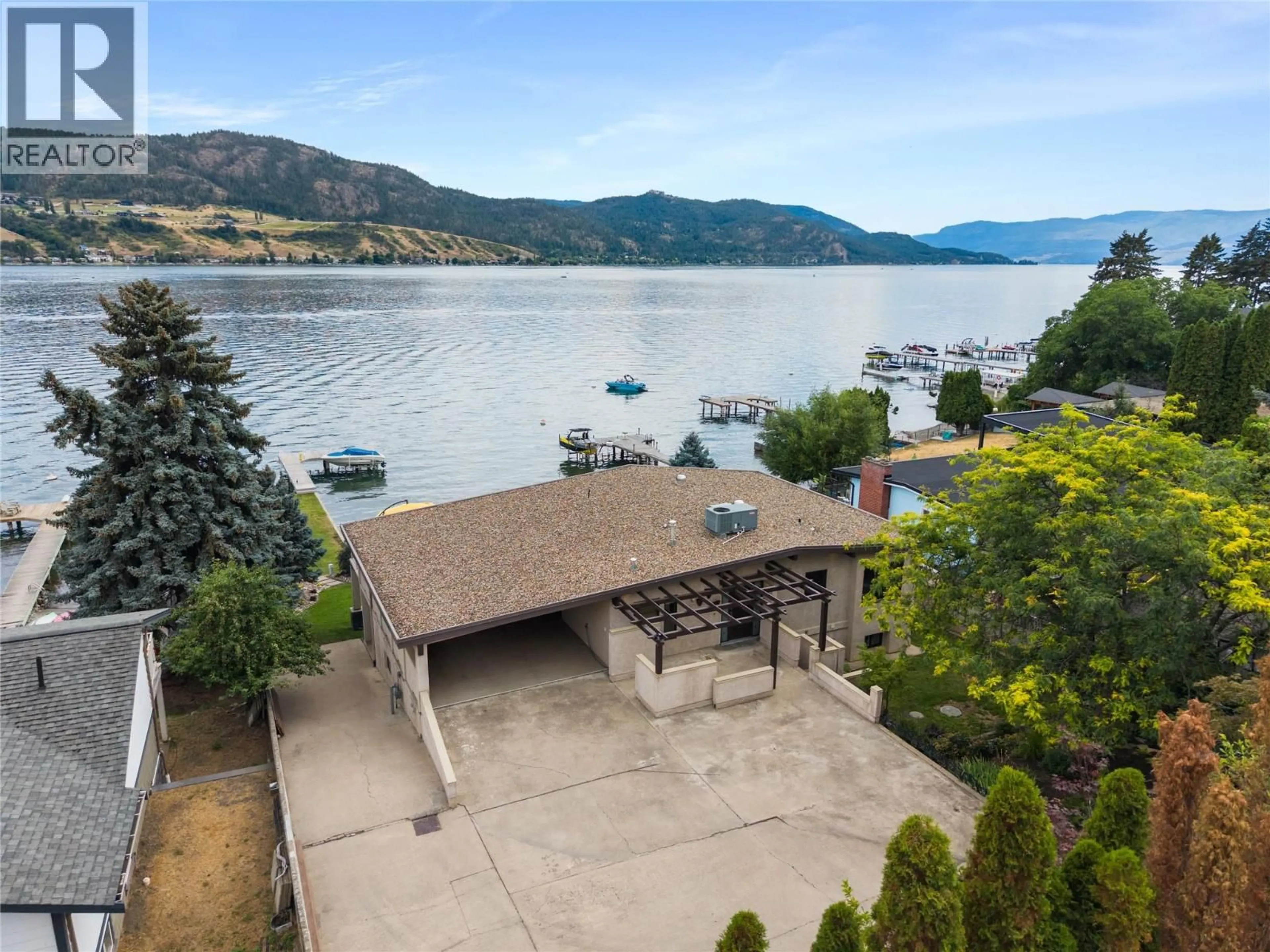 A pic from outside/outdoor area/front of a property/back of a property/a pic from drone, water/lake/river/ocean view for 8052 BEACHCOMBER BAY ROAD, Vernon British Columbia V1H1C7