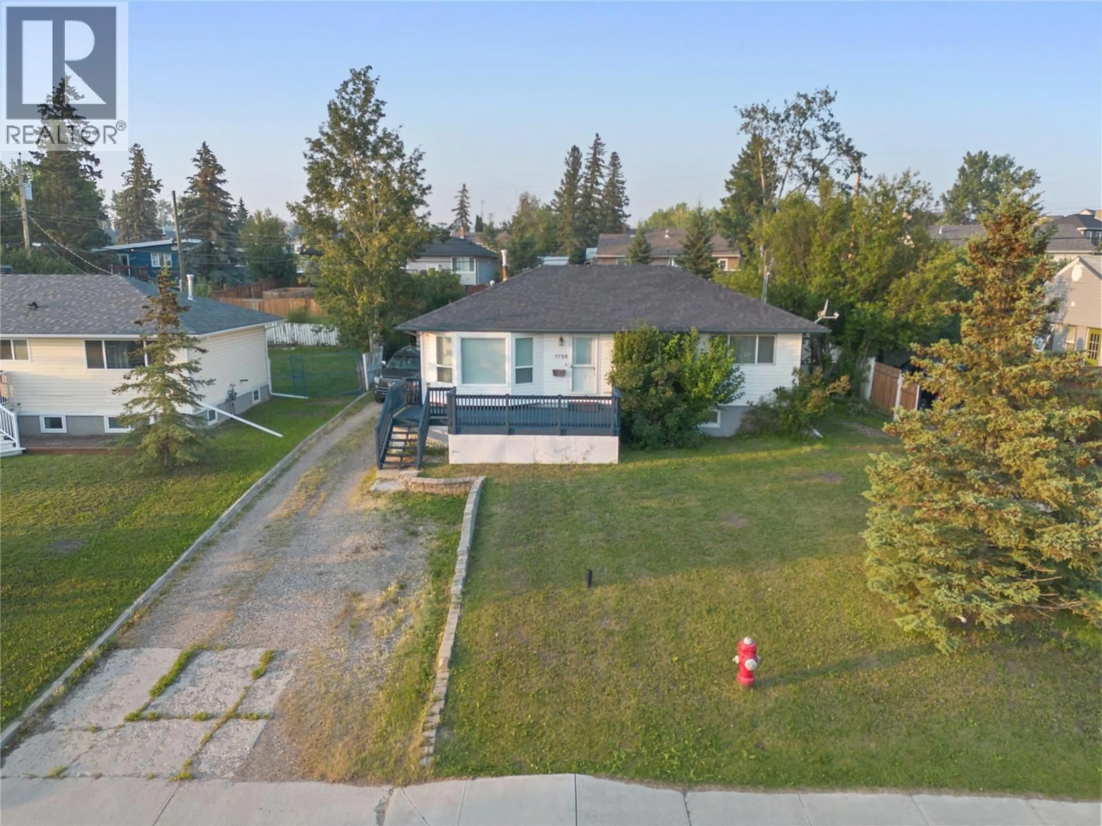 A pic from outside/outdoor area/front of a property/back of a property/a pic from drone, street for 1728 93 AVENUE, Dawson Creek British Columbia V1G1E6
