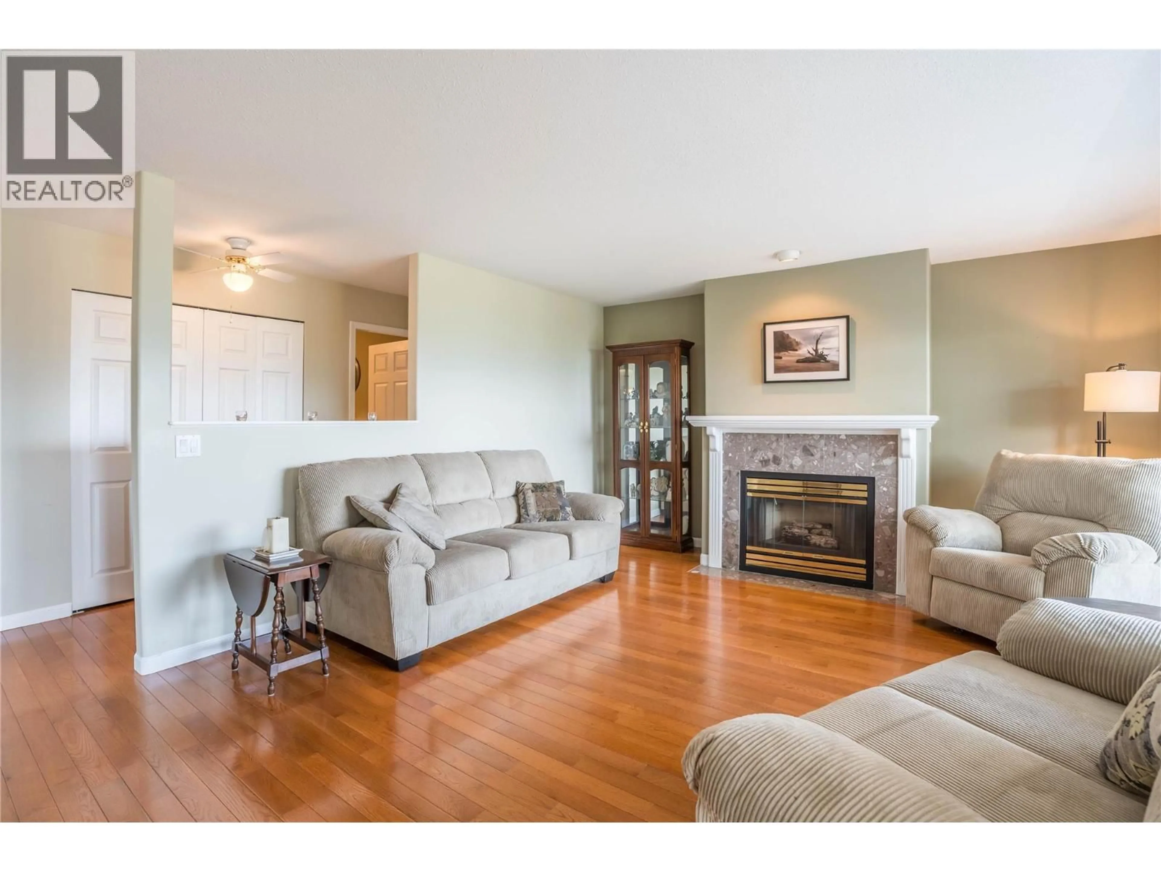 Living room with furniture, wood/laminate floor for 302 - 17456 SNOW AVENUE, Summerland British Columbia V0H1Z1