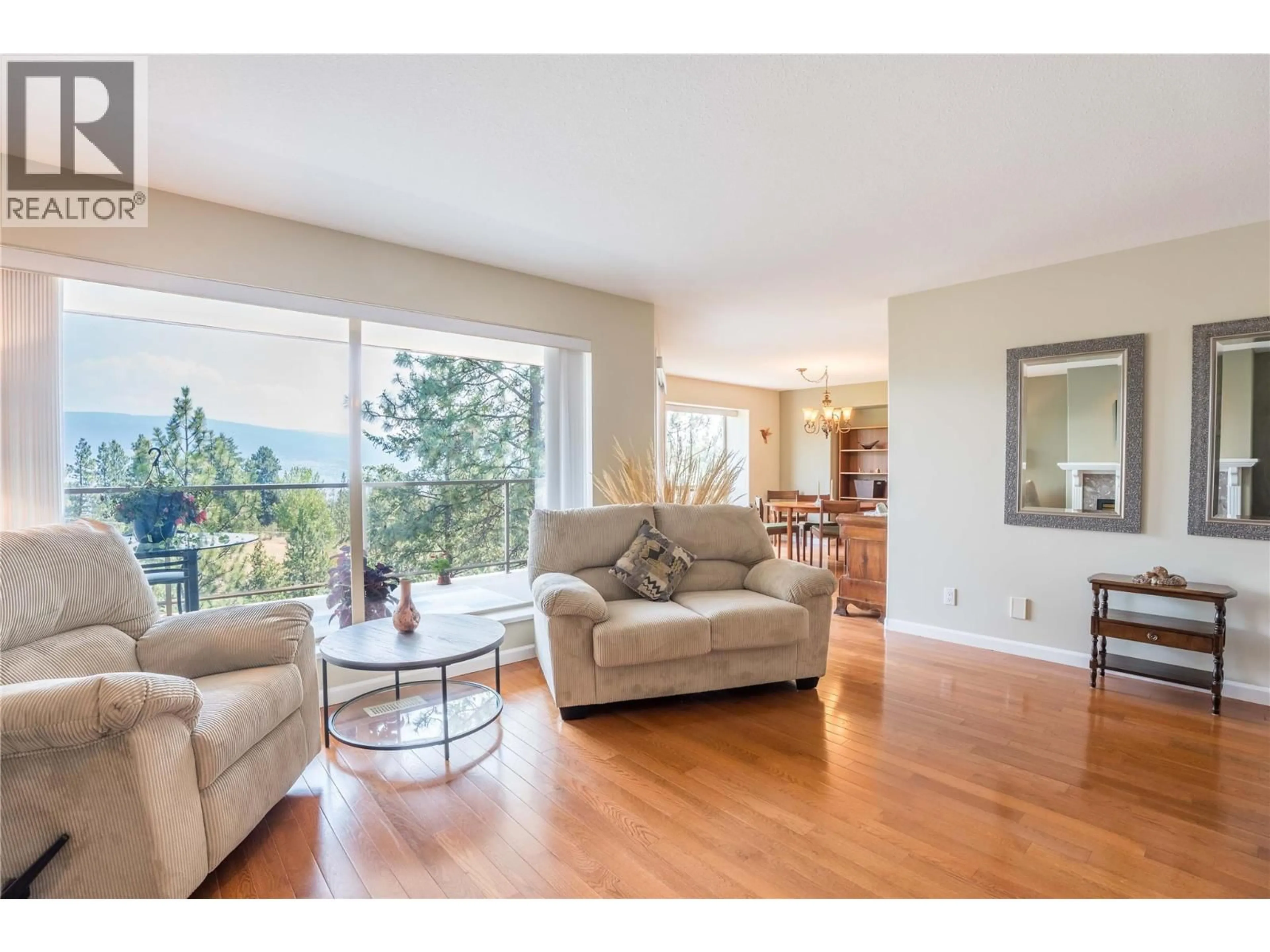 Living room with furniture, wood/laminate floor for 302 - 17456 SNOW AVENUE, Summerland British Columbia V0H1Z1
