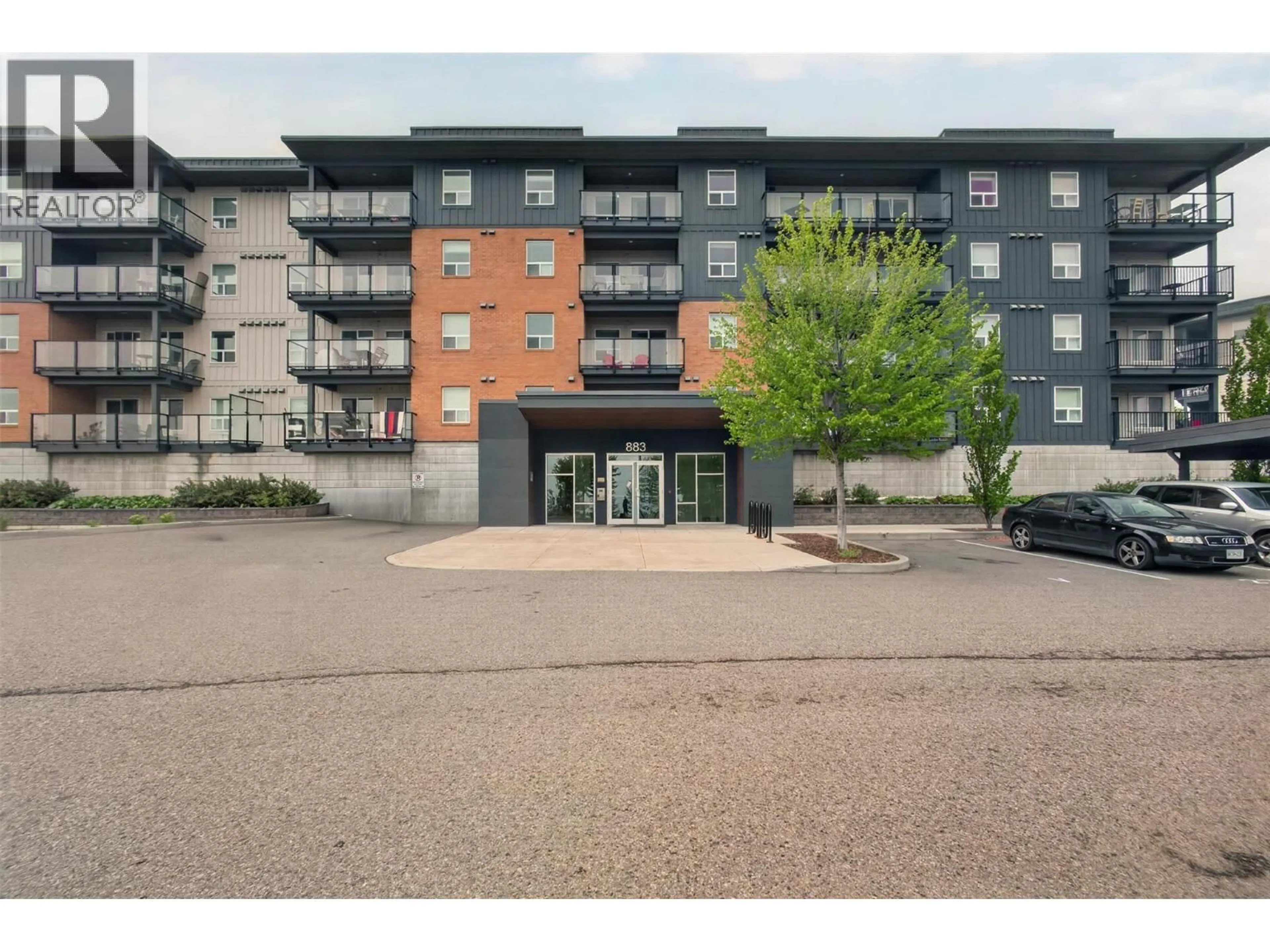 A pic from outside/outdoor area/front of a property/back of a property/a pic from drone, building for 103 - 883 ACADEMY WAY, Kelowna British Columbia V1V0A3
