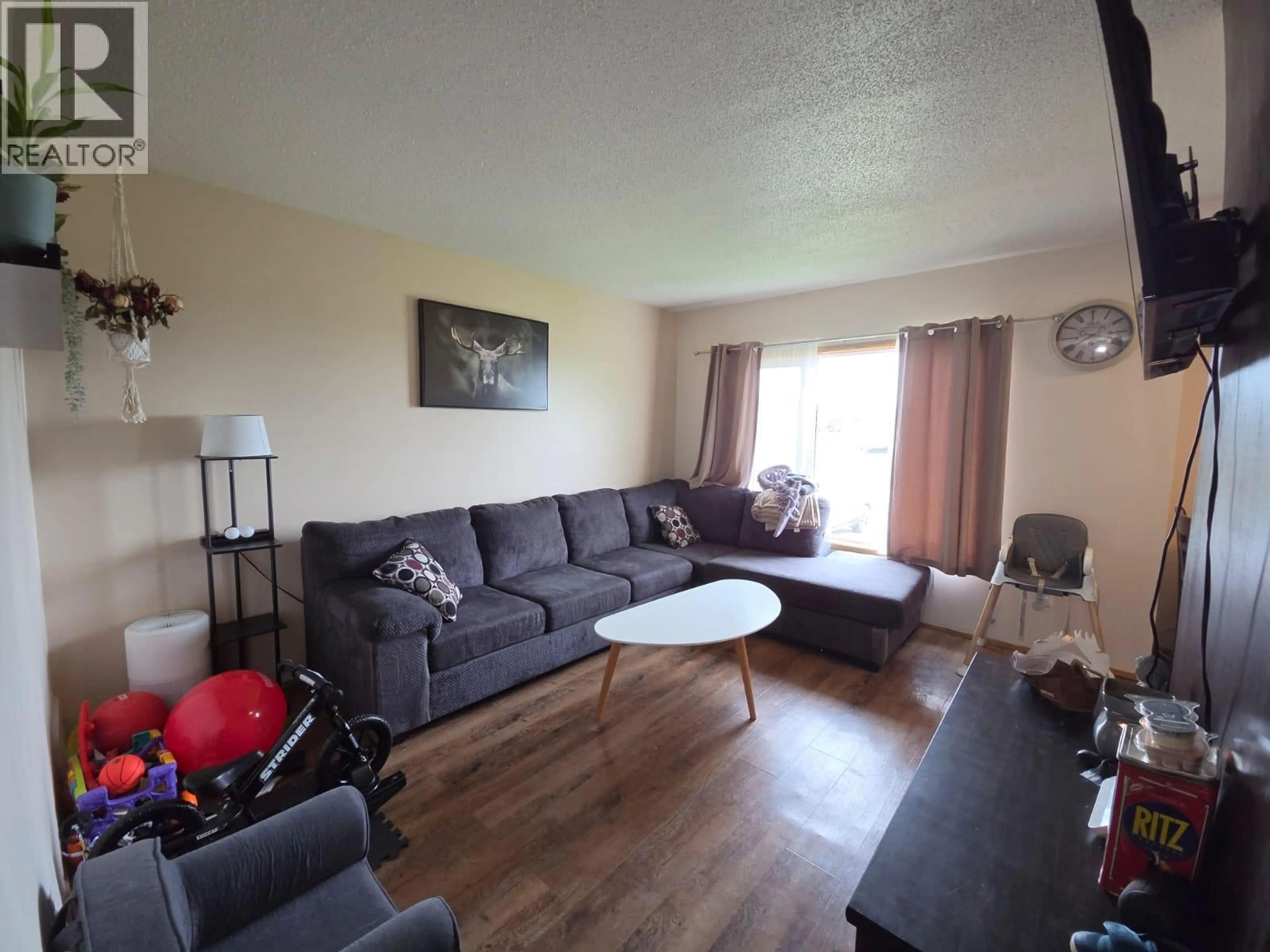 Living room with furniture, unknown for 4911/4913 56 AVENUE, Pouce Coupe British Columbia V0C2C0