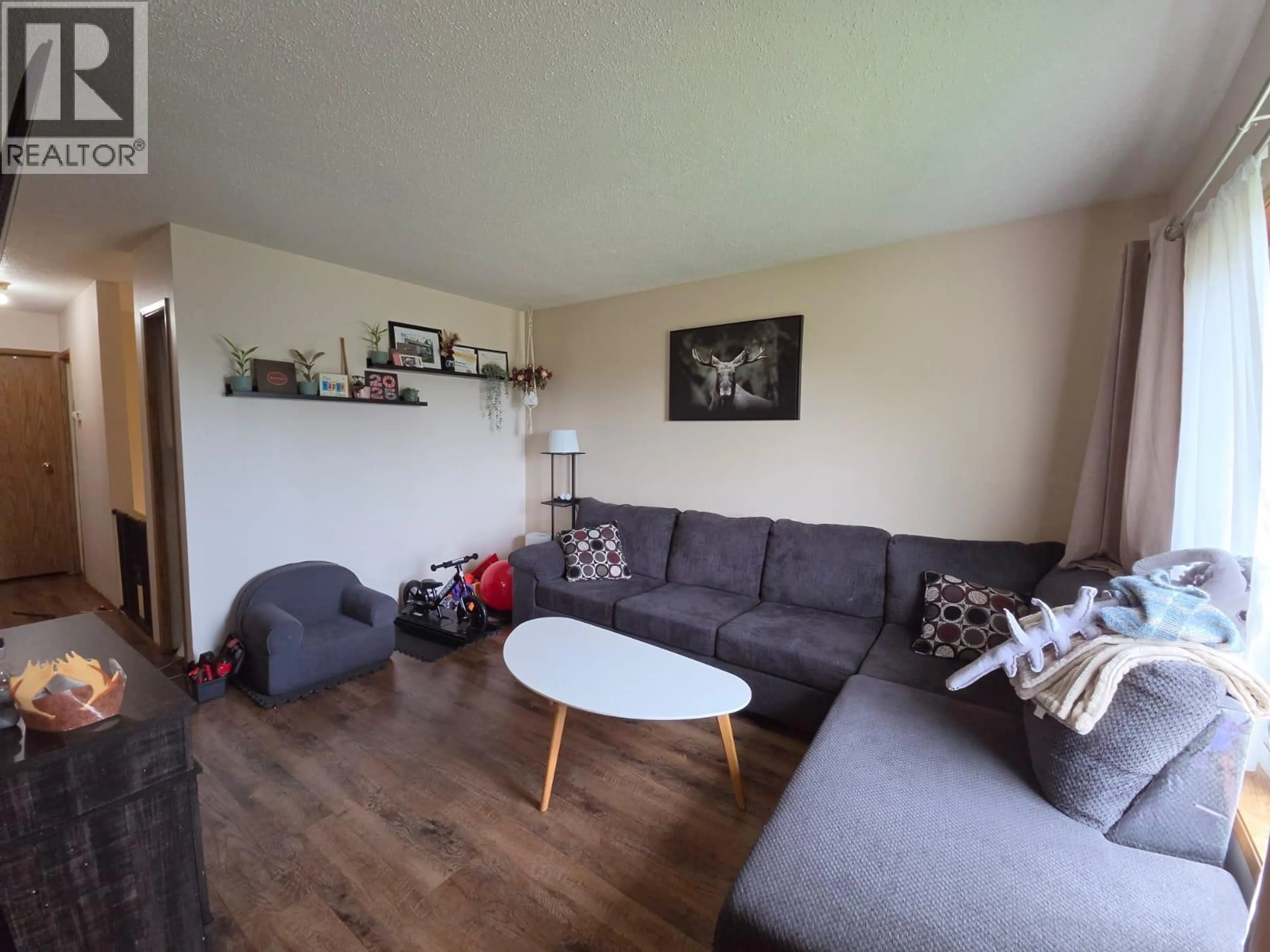 Living room with furniture, unknown for 4911/4913 56 AVENUE, Pouce Coupe British Columbia V0C2C0