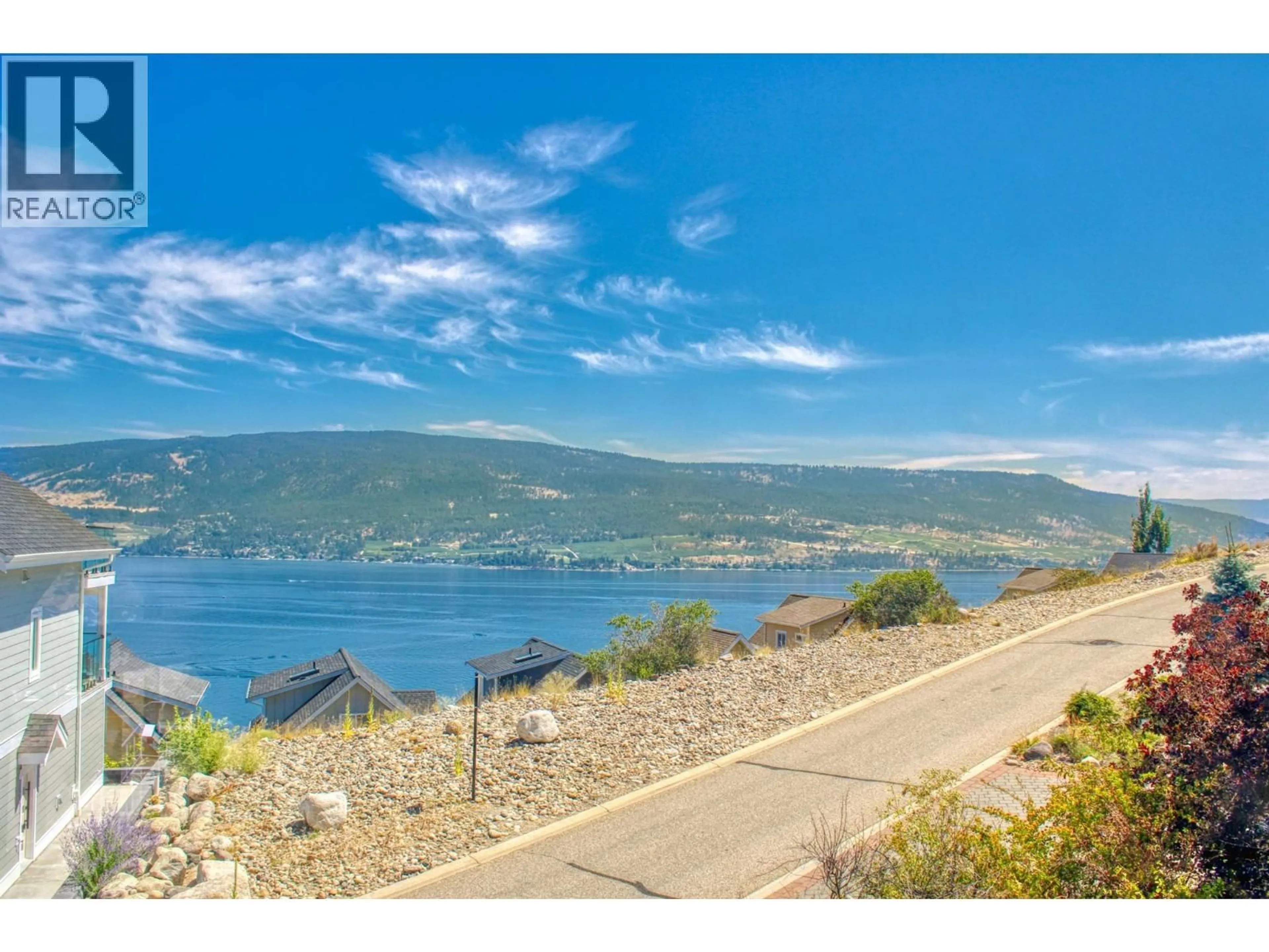 A pic from outside/outdoor area/front of a property/back of a property/a pic from drone, water/lake/river/ocean view for 160 - 6810 SANTIAGO LOOP, Kelowna British Columbia V1Z3R8