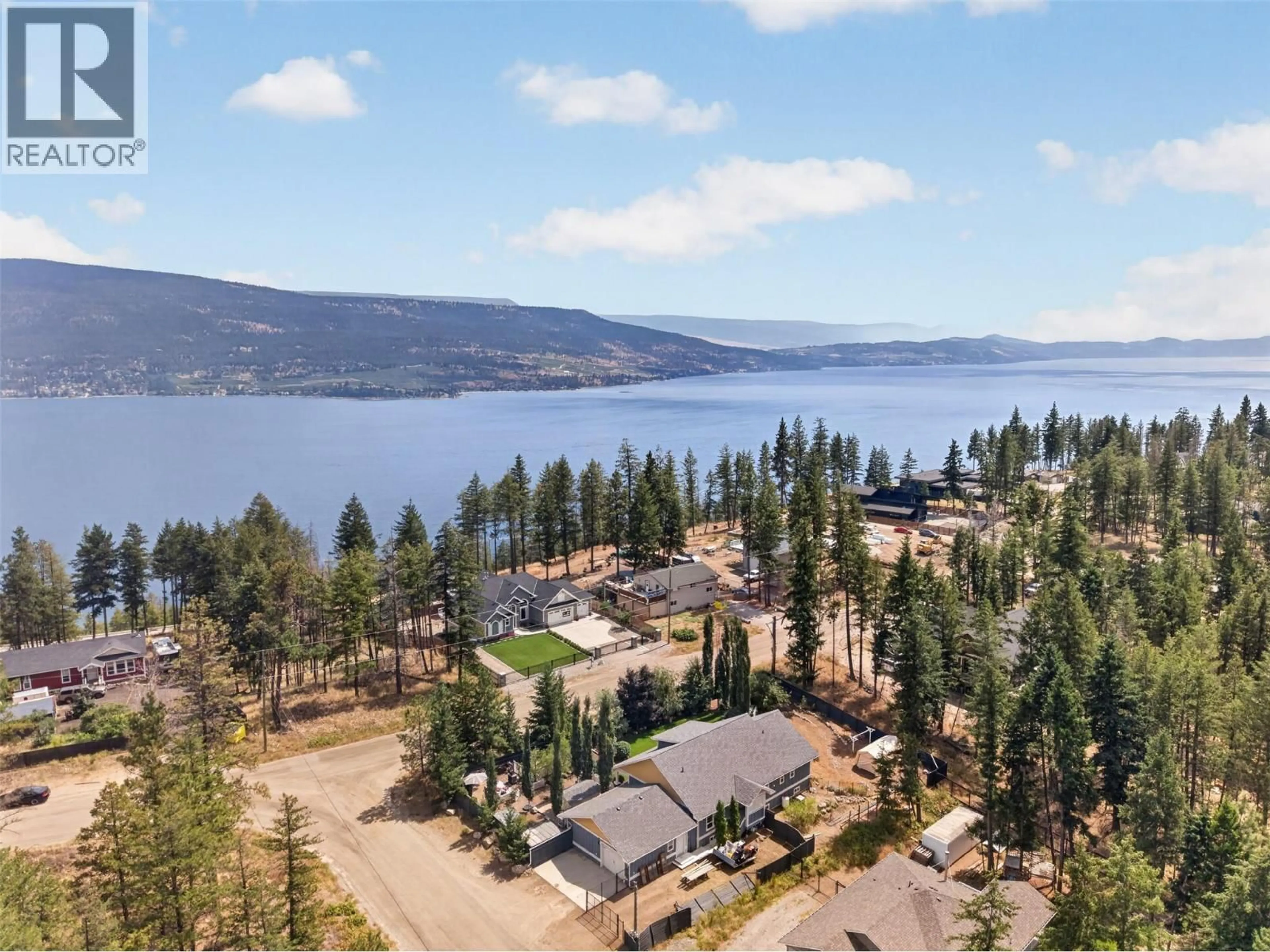 A pic from outside/outdoor area/front of a property/back of a property/a pic from drone, water/lake/river/ocean view for 7272 DUNWATERS ROAD, Kelowna British Columbia V1Z3W4