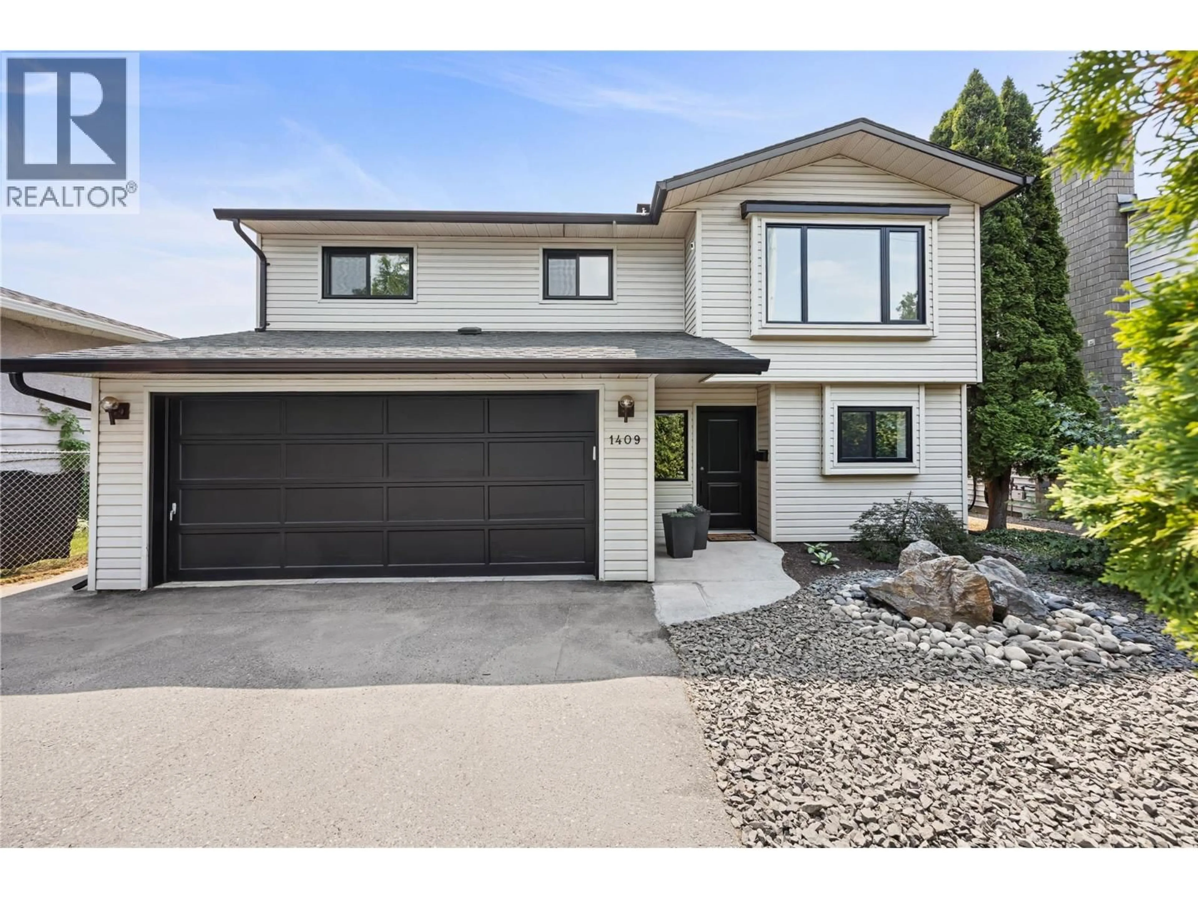 Home with vinyl exterior material, street for 1409 SPRINGFIELD ROAD, Kelowna British Columbia V1Y5V2