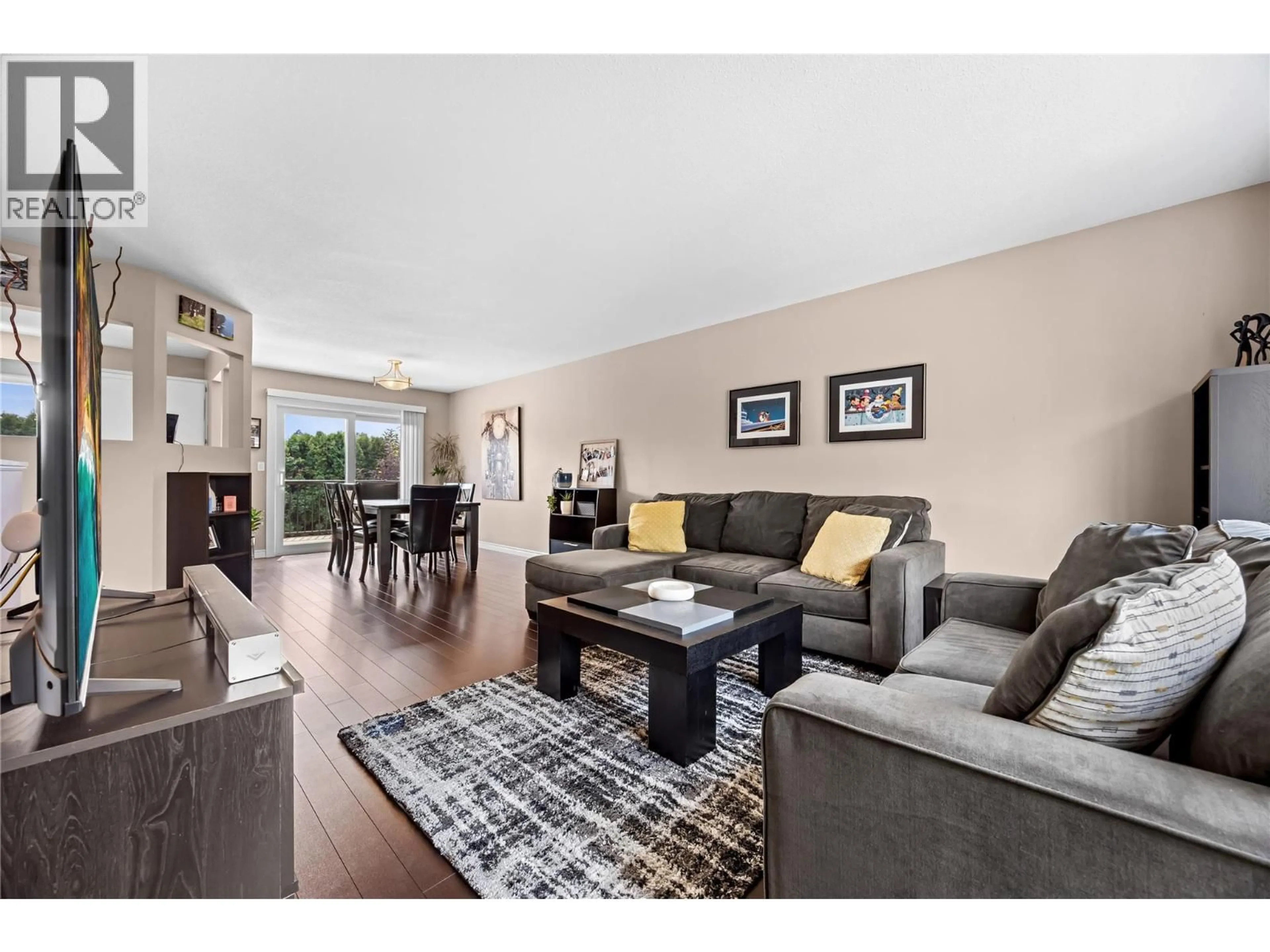 Living room with furniture, wood/laminate floor for 1409 SPRINGFIELD ROAD, Kelowna British Columbia V1Y5V2