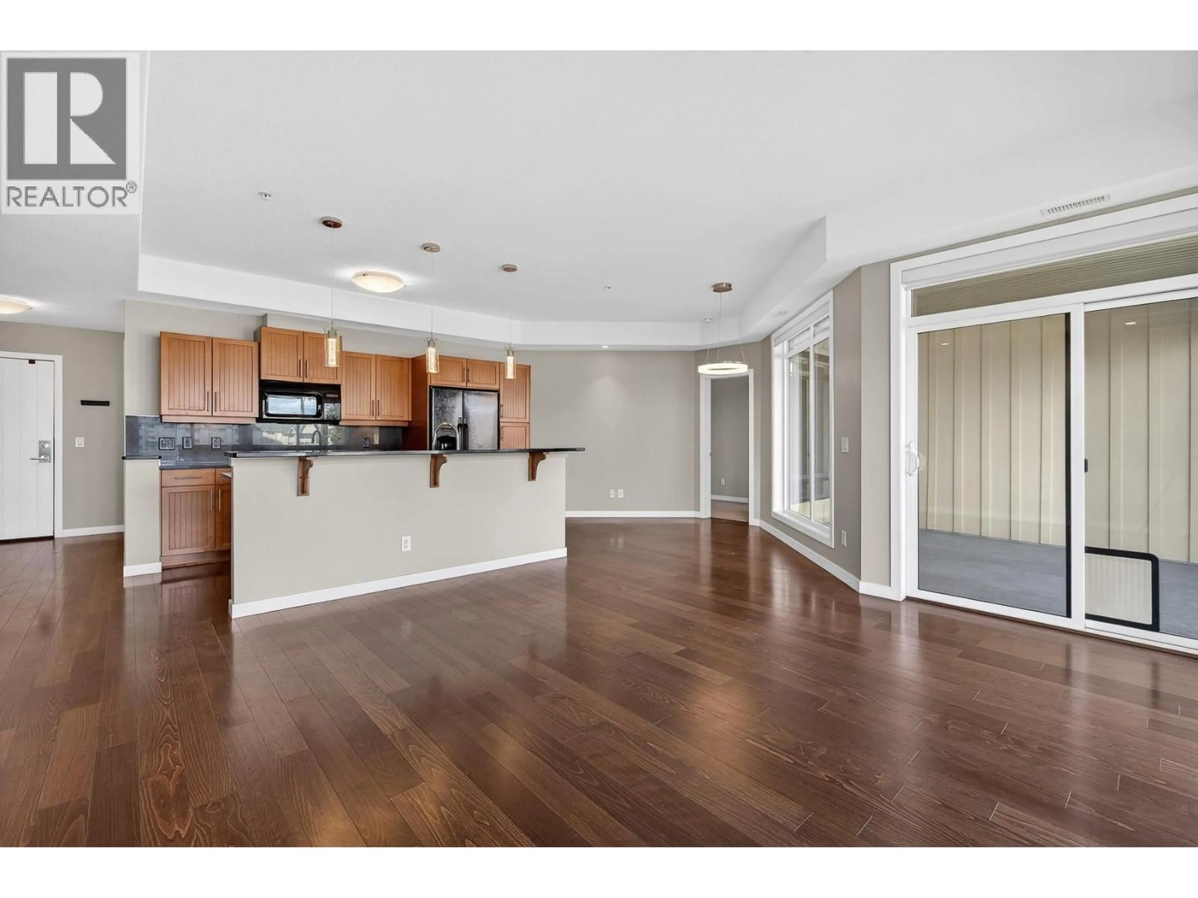 Open concept kitchen, wood/laminate floor for 306 - 1933 AMBROSI ROAD, Kelowna British Columbia V1Y4S1
