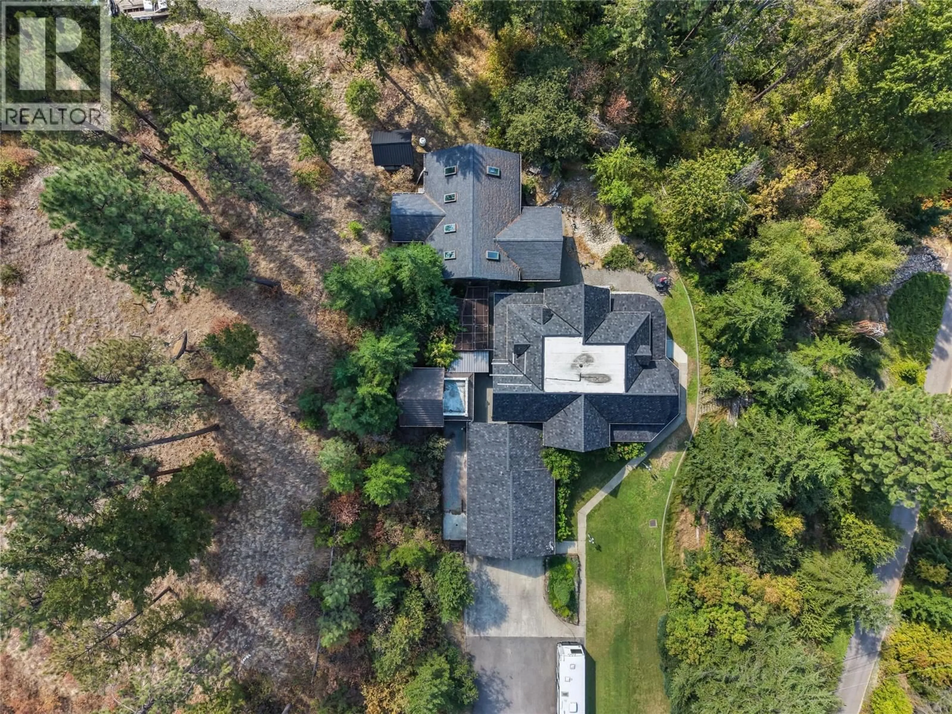A pic from outside/outdoor area/front of a property/back of a property/a pic from drone, street for 4345 JUNE SPRINGS ROAD, Kelowna British Columbia V1W4C8