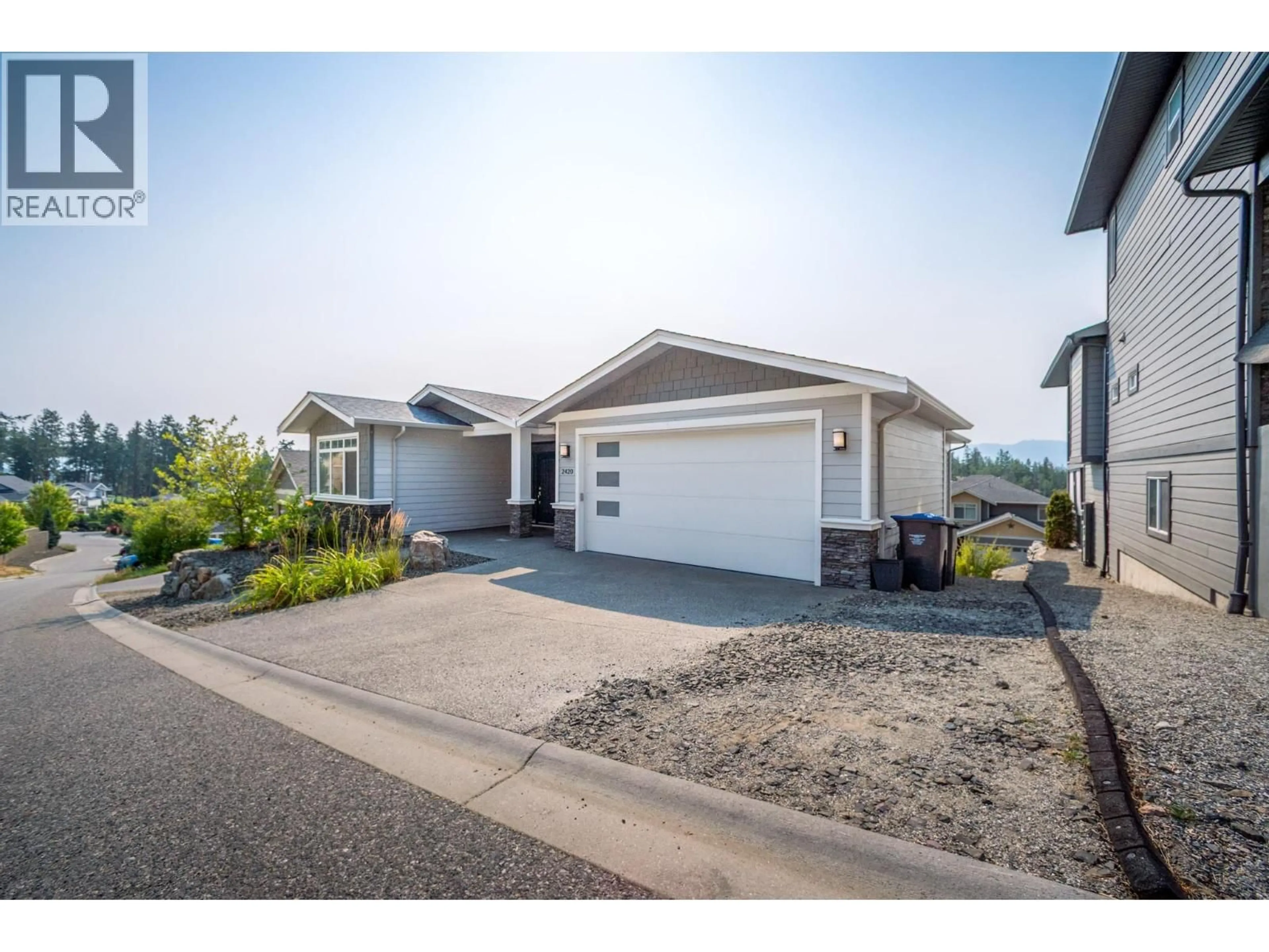 Home with vinyl exterior material, street for 2420 TALLUS HEIGHTS DRIVE, West Kelowna British Columbia V4T3M2