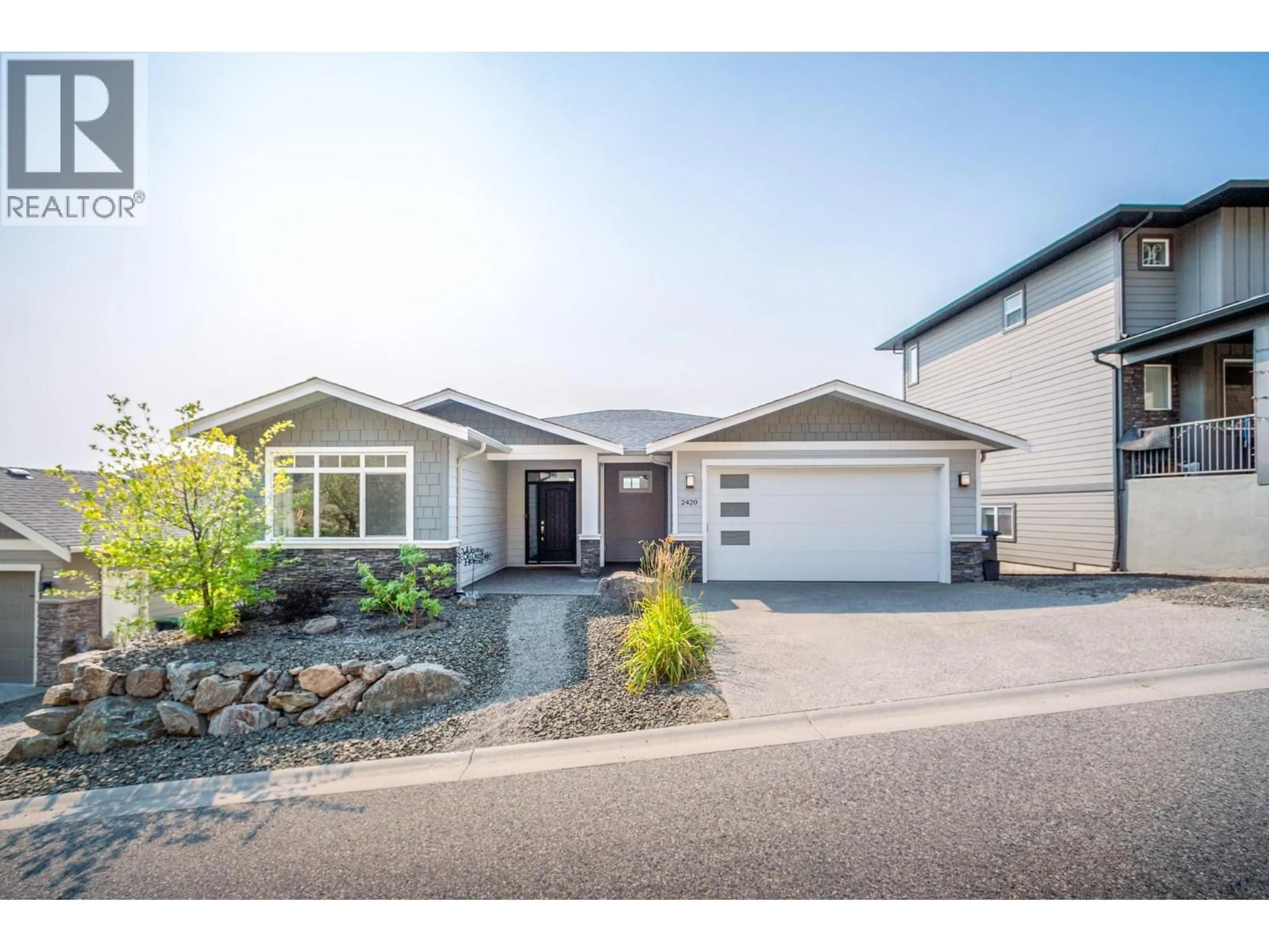 Home with vinyl exterior material, street for 2420 TALLUS HEIGHTS DRIVE, West Kelowna British Columbia V4T3M2