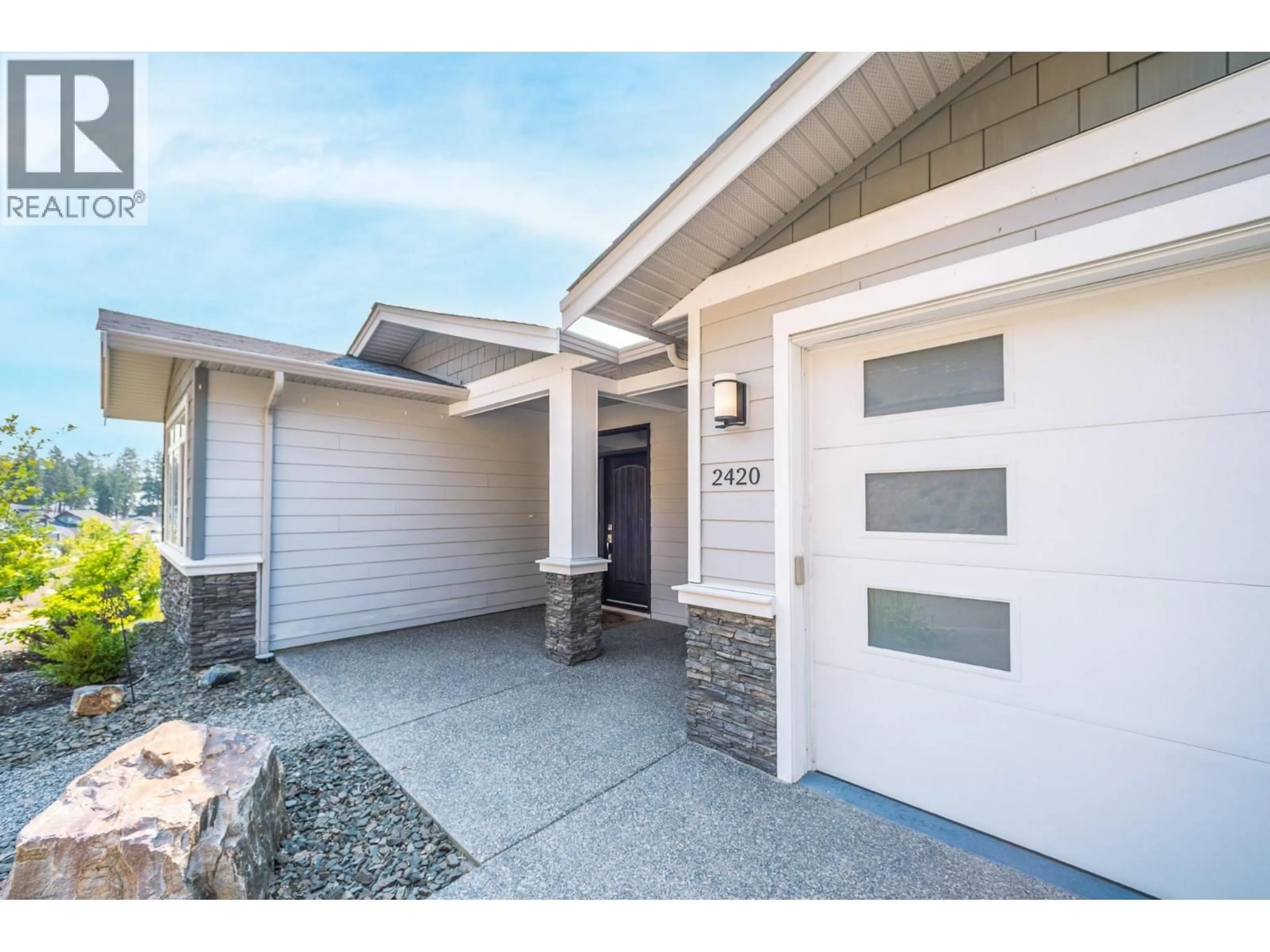 Home with vinyl exterior material, street for 2420 TALLUS HEIGHTS DRIVE, West Kelowna British Columbia V4T3M2