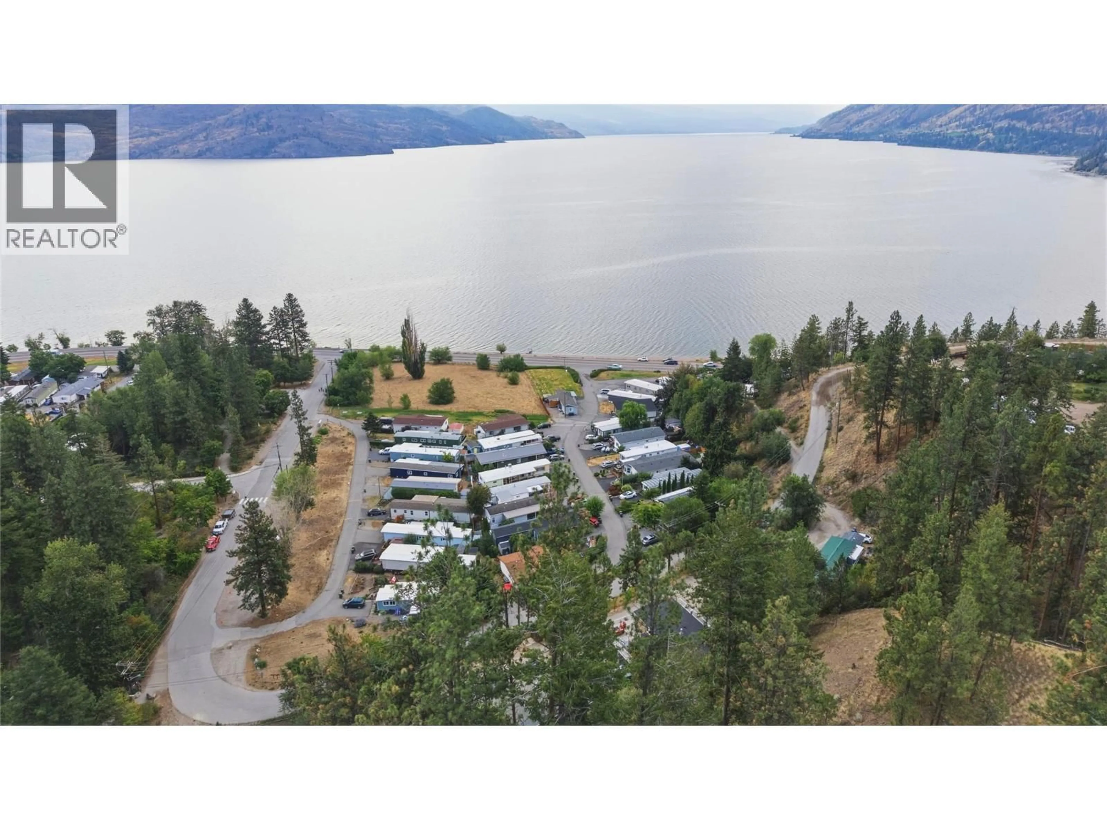 A pic from outside/outdoor area/front of a property/back of a property/a pic from drone, water/lake/river/ocean view for 32 - 6711 HIGHWAY 97 OTHER SOUTH, Peachland British Columbia V0H1X9