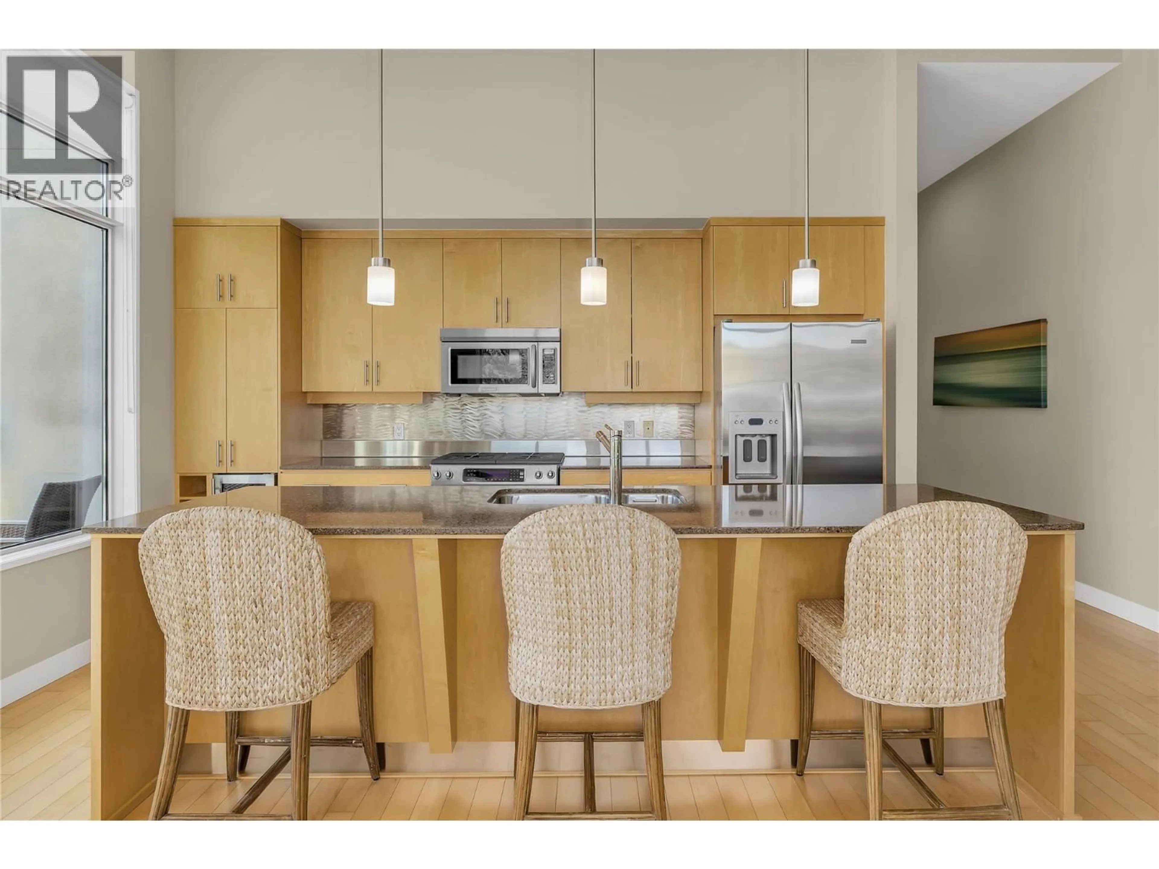 Open concept kitchen, wood/laminate floor for 409 - 1495 GRAHAM STREET, Kelowna British Columbia V1Y3B2