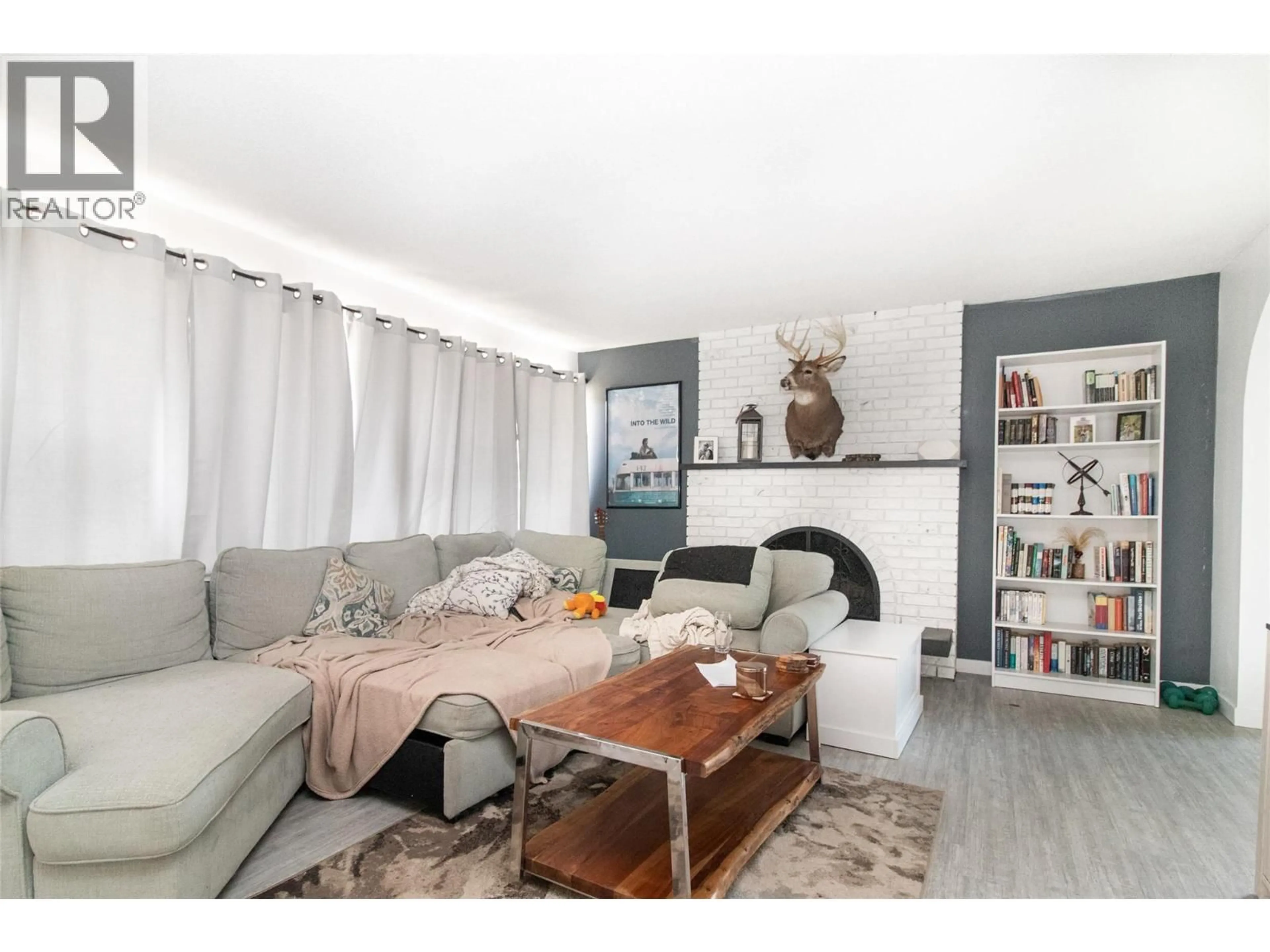 Living room with furniture, wood/laminate floor for 700 MATT ROAD, Kelowna British Columbia V1X3V9
