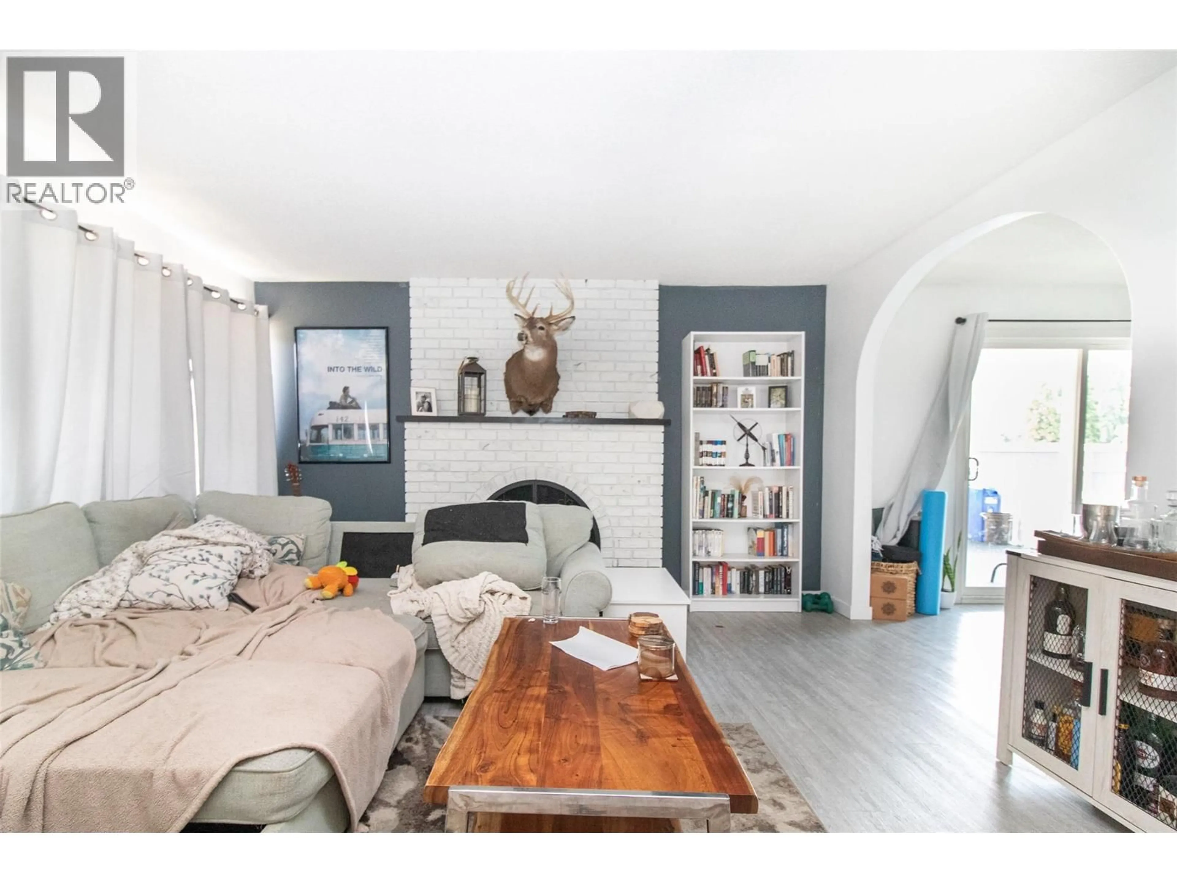 Living room with furniture, wood/laminate floor for 700 MATT ROAD, Kelowna British Columbia V1X3V9