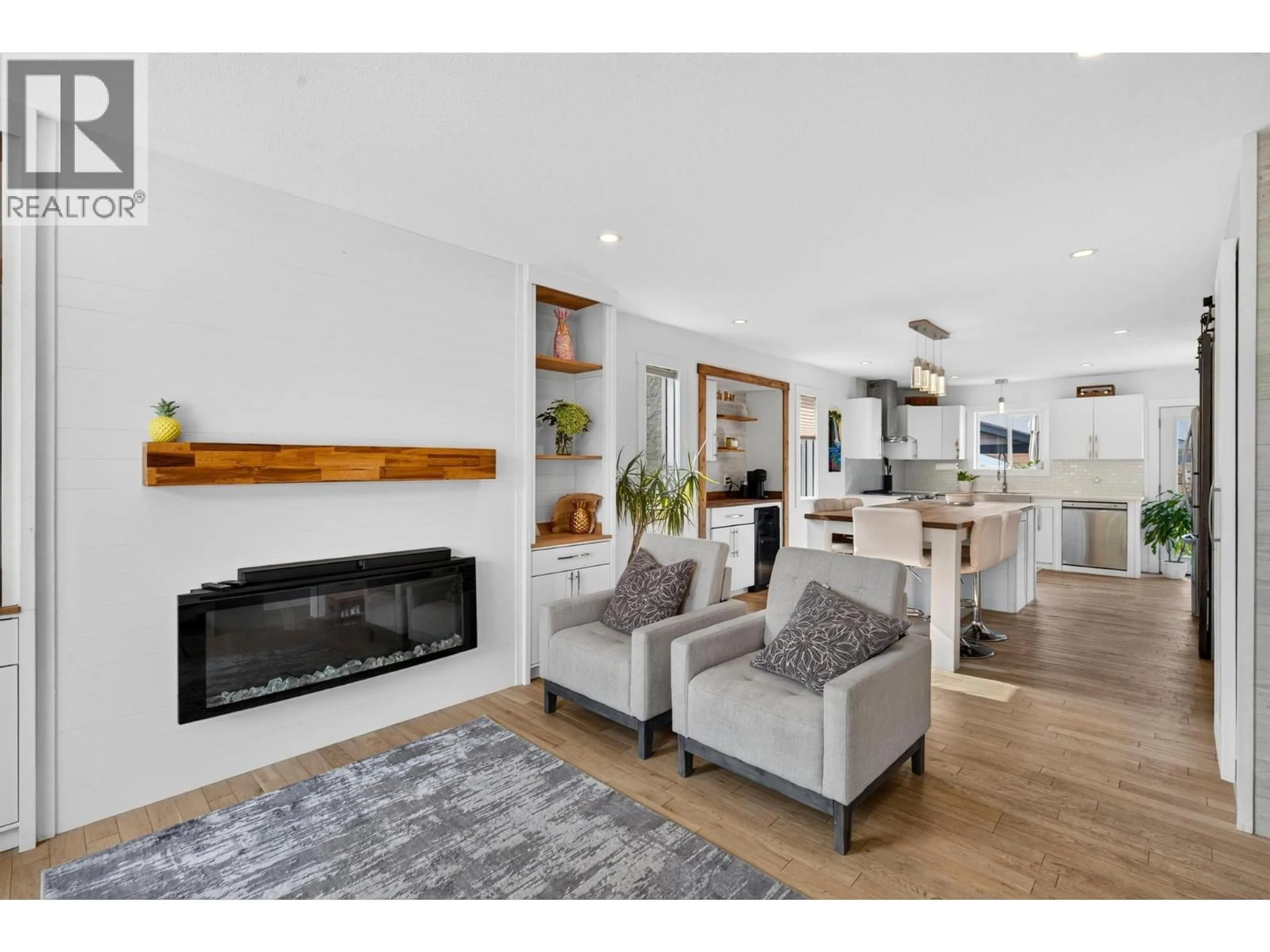 Living room with furniture, wood/laminate floor for 853 SPRINGSIDE COURT, Kelowna British Columbia V1W3L8
