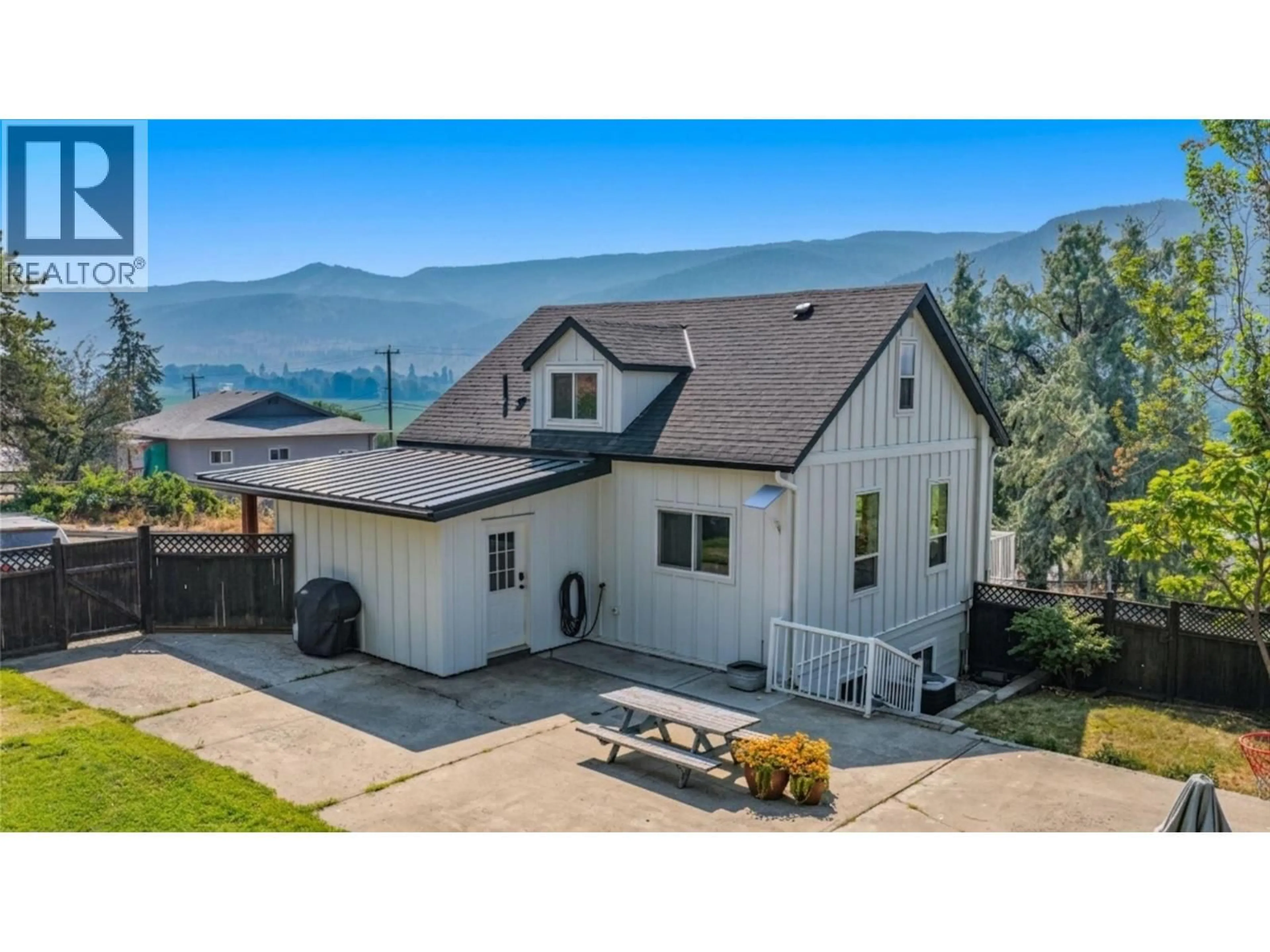 A pic from outside/outdoor area/front of a property/back of a property/a pic from drone, mountain view for 9211 6 HIGHWAY, Coldstream British Columbia V1B3B5