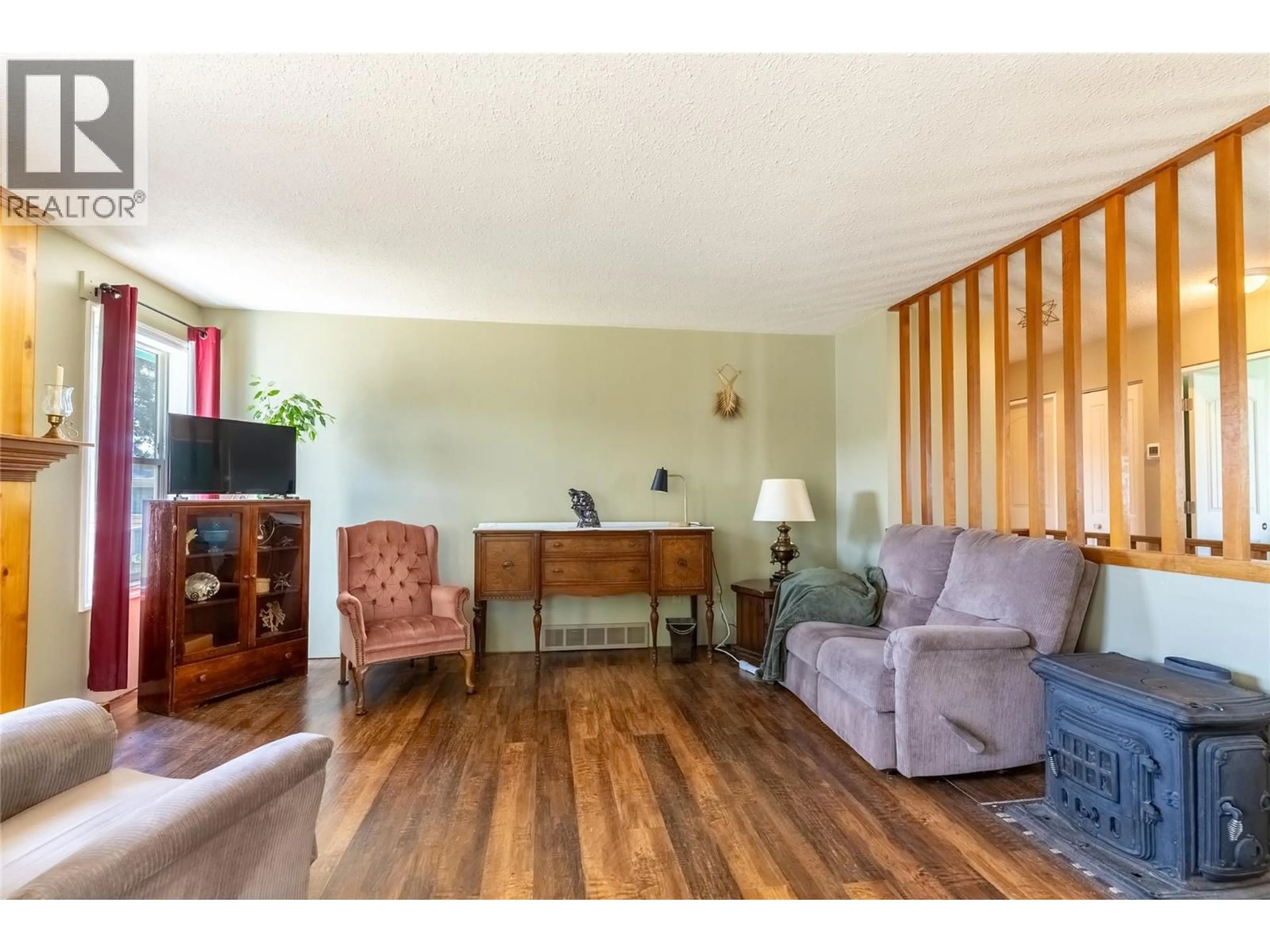 Living room with furniture, wood/laminate floor for 297 CHESTNUT COURT, Logan Lake British Columbia V0K1W0