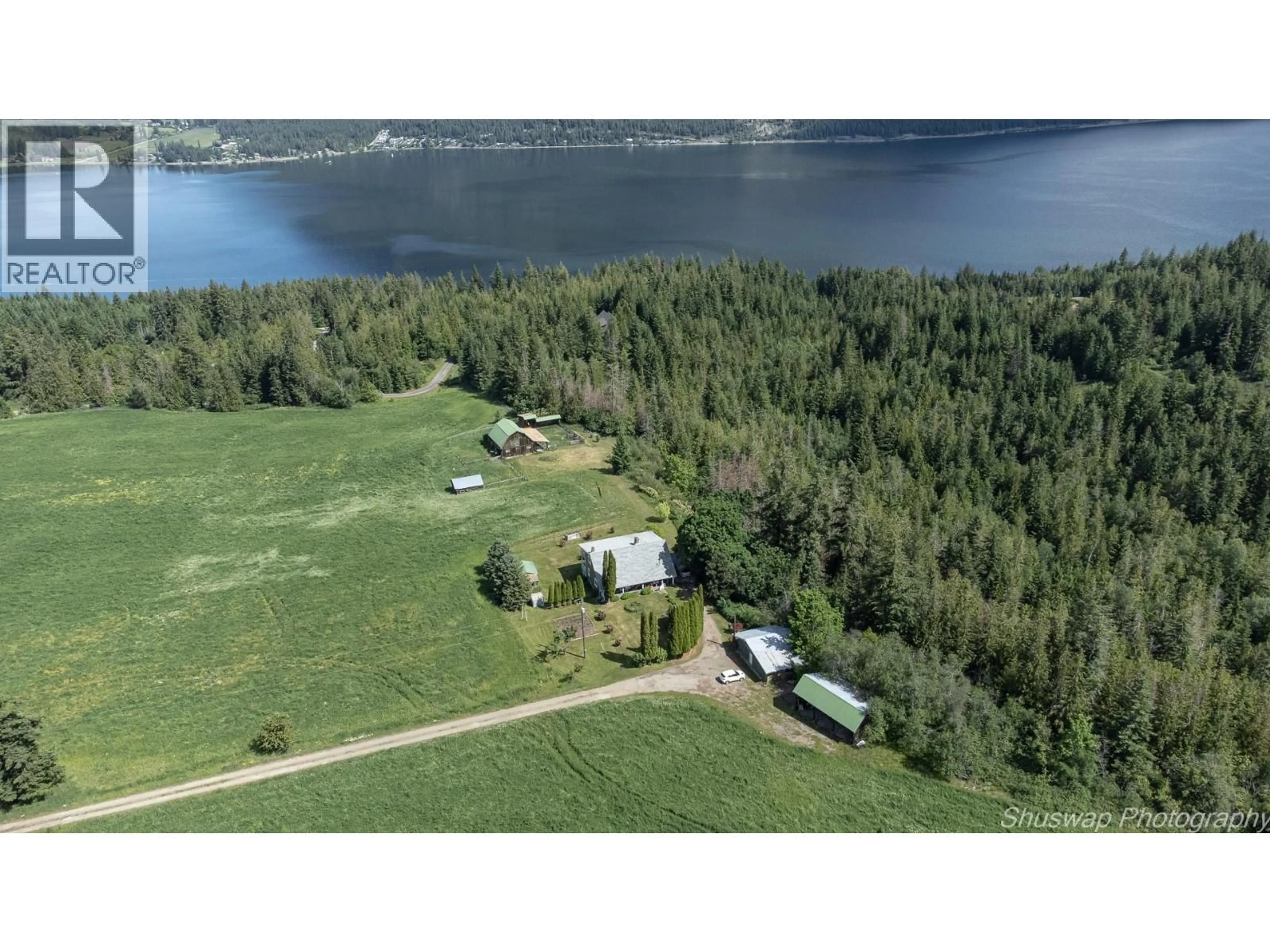 A pic from outside/outdoor area/front of a property/back of a property/a pic from drone, water/lake/river/ocean view for 6350 LAKESHORE DRIVE NORTHEAST, Salmon Arm British Columbia V1E4N1