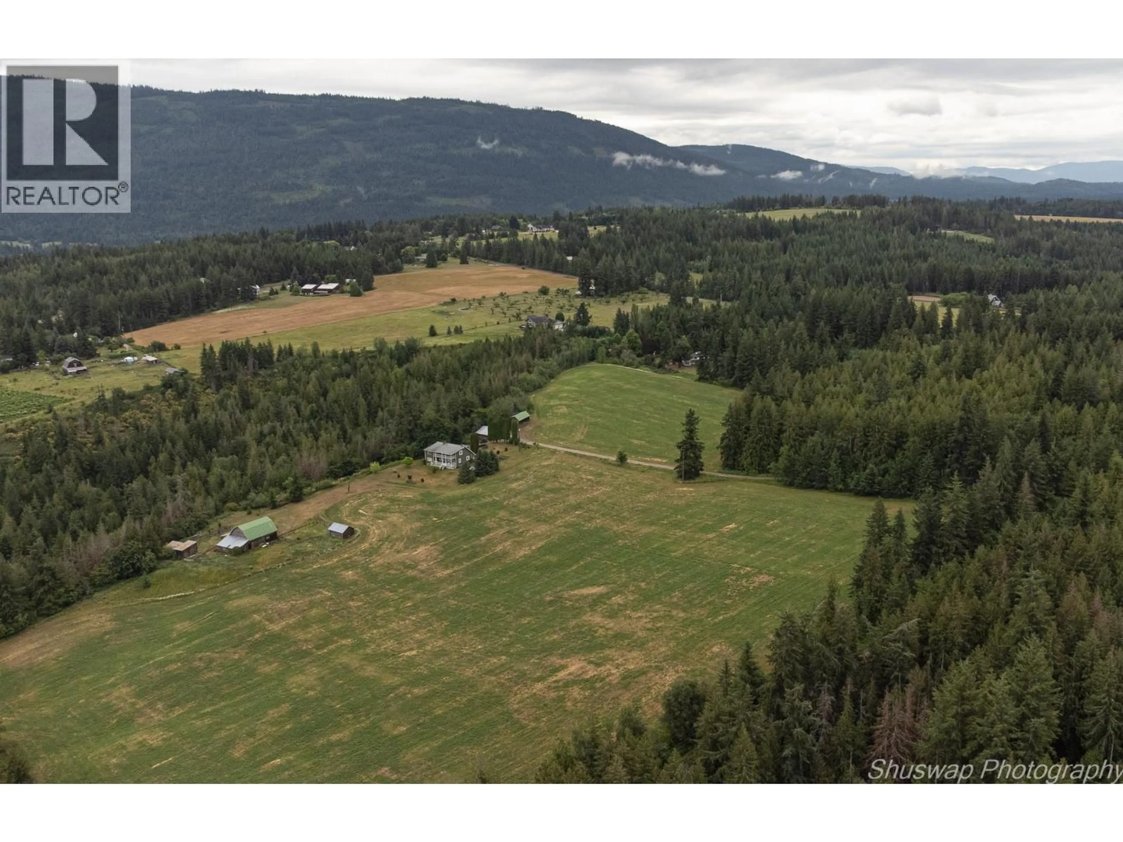 A pic from outside/outdoor area/front of a property/back of a property/a pic from drone, mountain view for 6350 LAKESHORE DRIVE NORTHEAST, Salmon Arm British Columbia V1E4N1