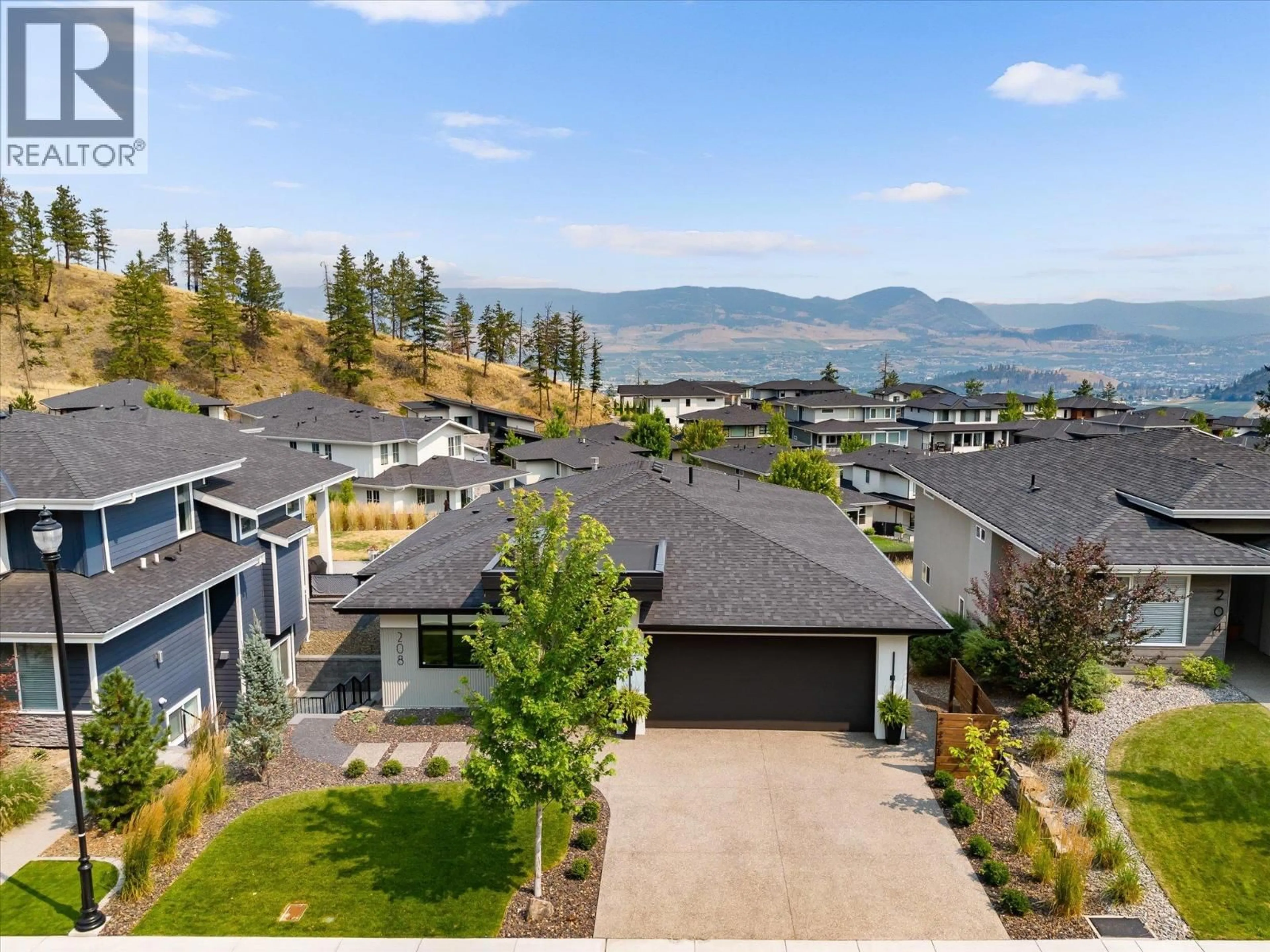A pic from outside/outdoor area/front of a property/back of a property/a pic from drone, mountain view for 208 SKYLAND DRIVE, Kelowna British Columbia V1V0C9