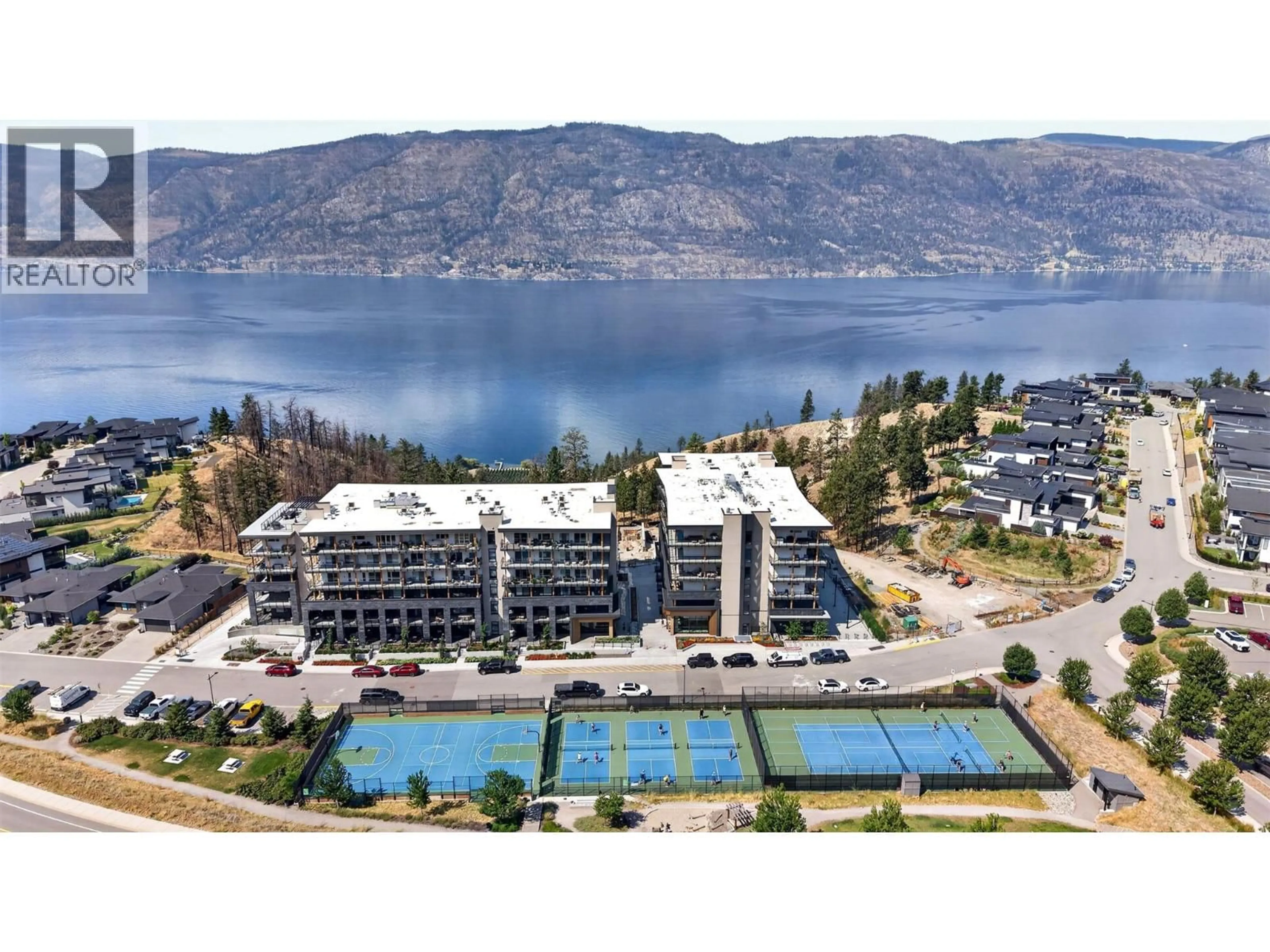 A pic from outside/outdoor area/front of a property/back of a property/a pic from drone, water/lake/river/ocean view for 209 - 9652 BENCHLAND DRIVE, Lake Country British Columbia V4V1N3