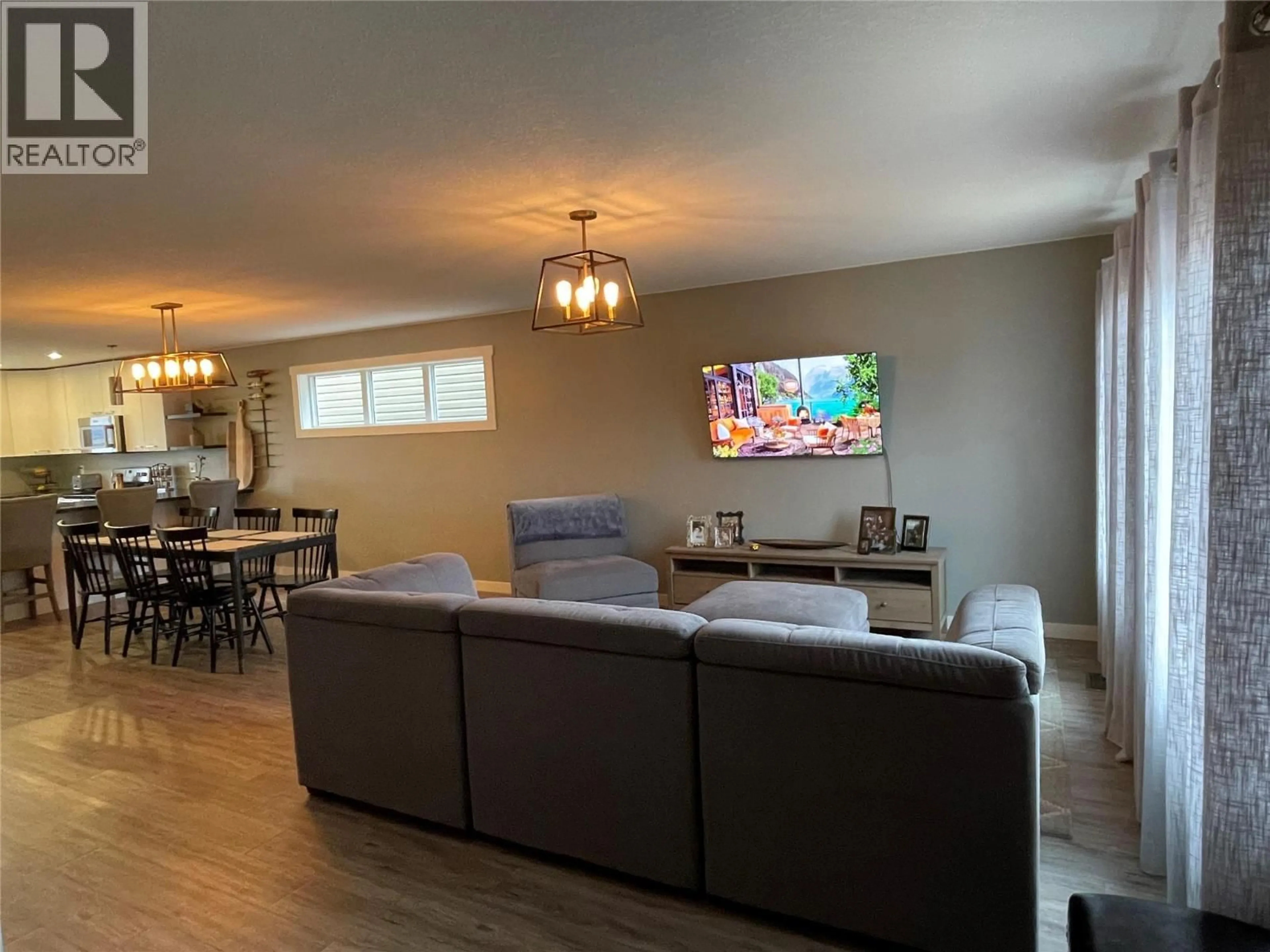 Living room with furniture, wood/laminate floor for 8221 19A STREET, Dawson Creek British Columbia V1G0J6