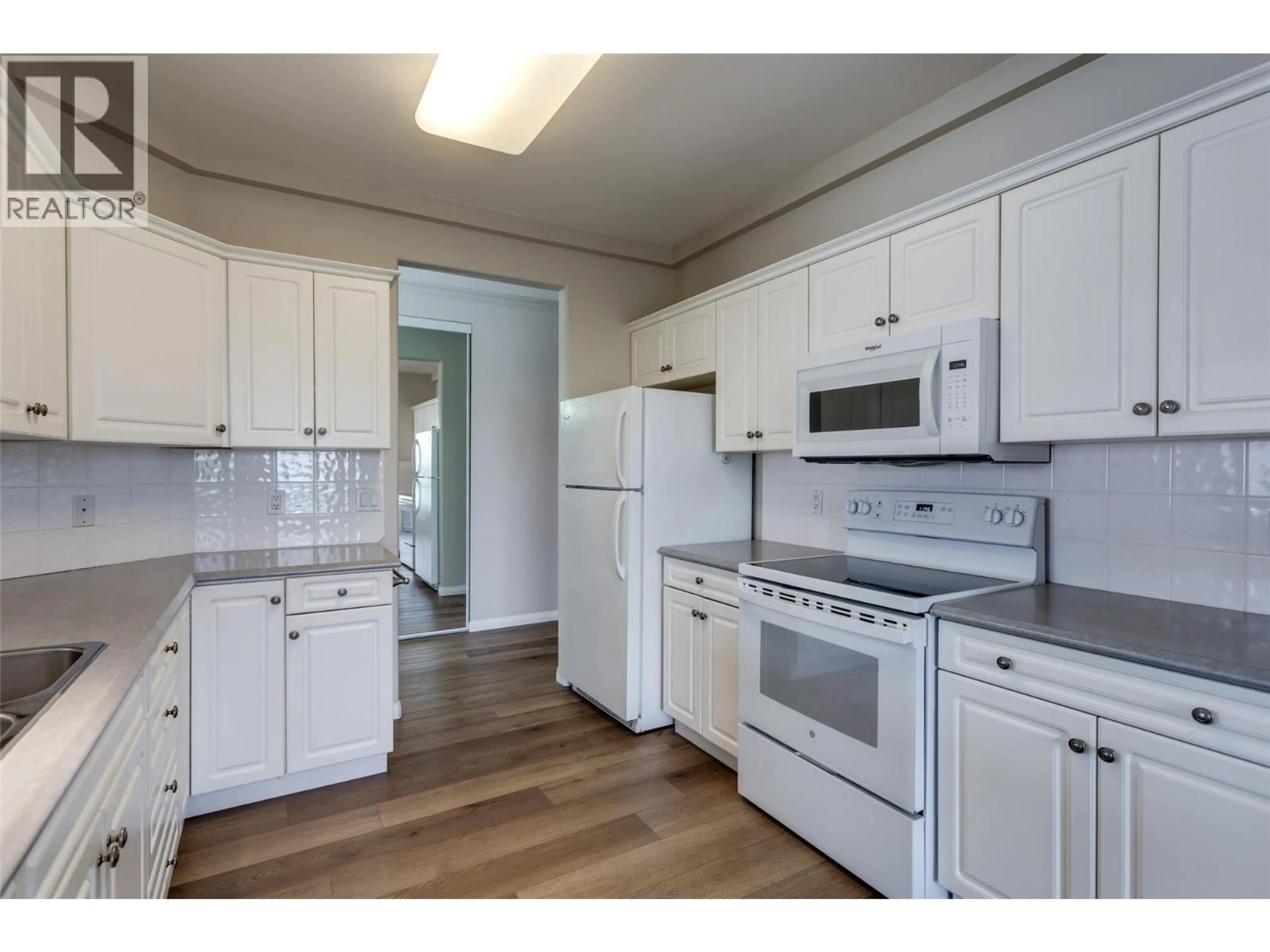 Standard kitchen, wood/laminate floor for 401 - 1962 ENTERPRISE WAY, Kelowna British Columbia V1Y9S6