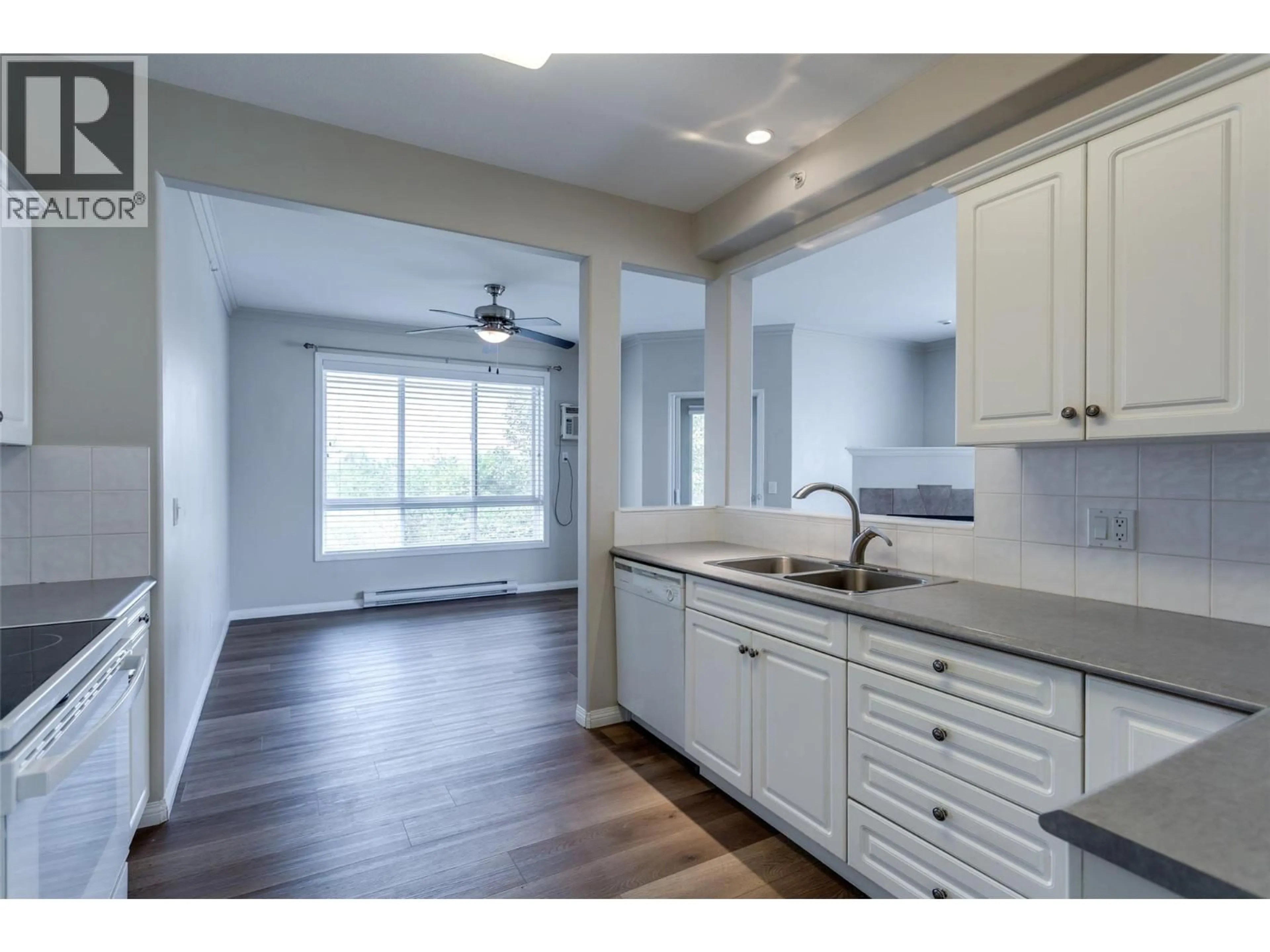 Open concept kitchen, wood/laminate floor for 401 - 1962 ENTERPRISE WAY, Kelowna British Columbia V1Y9S6