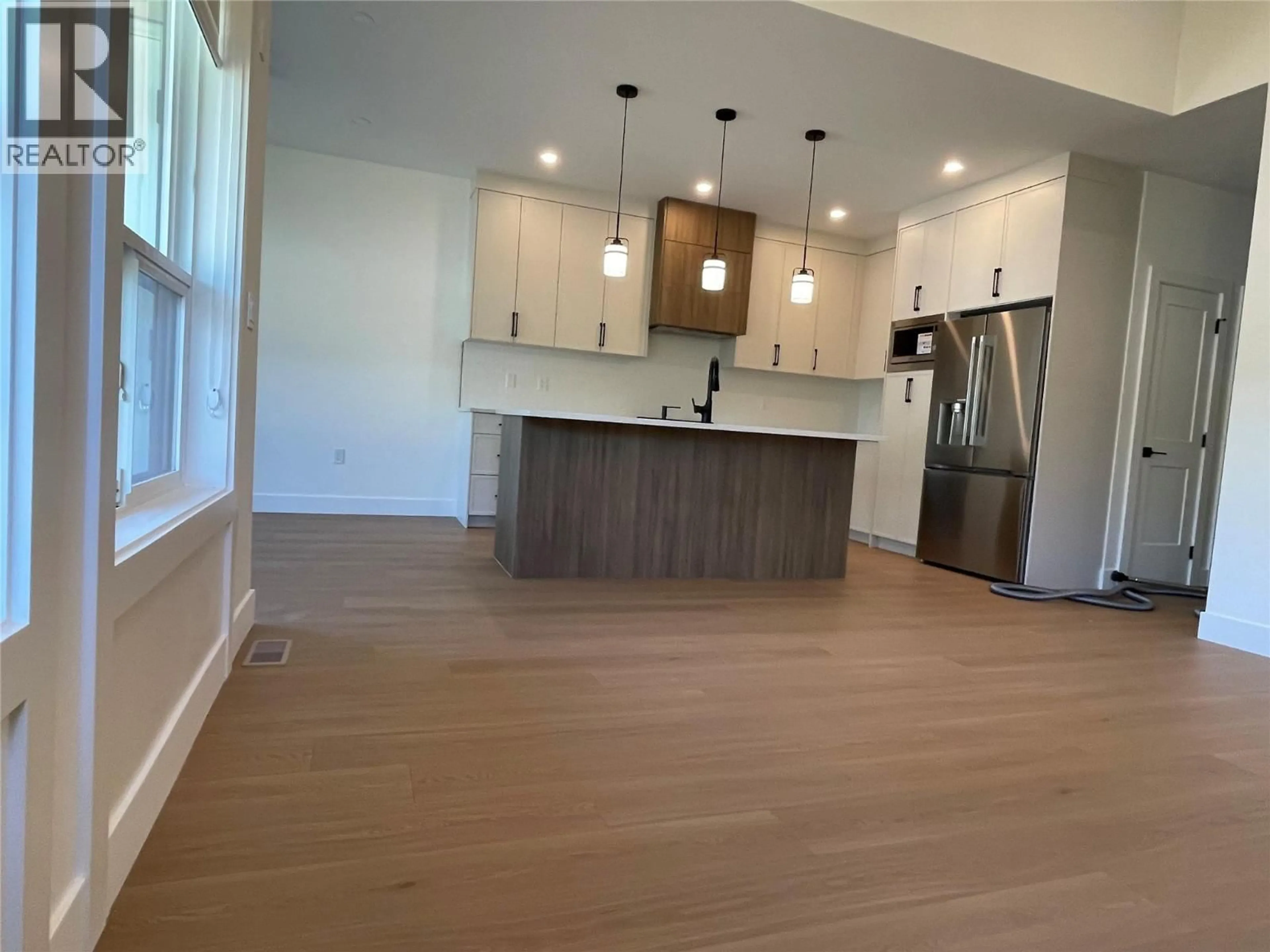 Open concept kitchen, wood/laminate floor for 1 - 304 SUMAC ROAD, Kelowna British Columbia V1X6W8