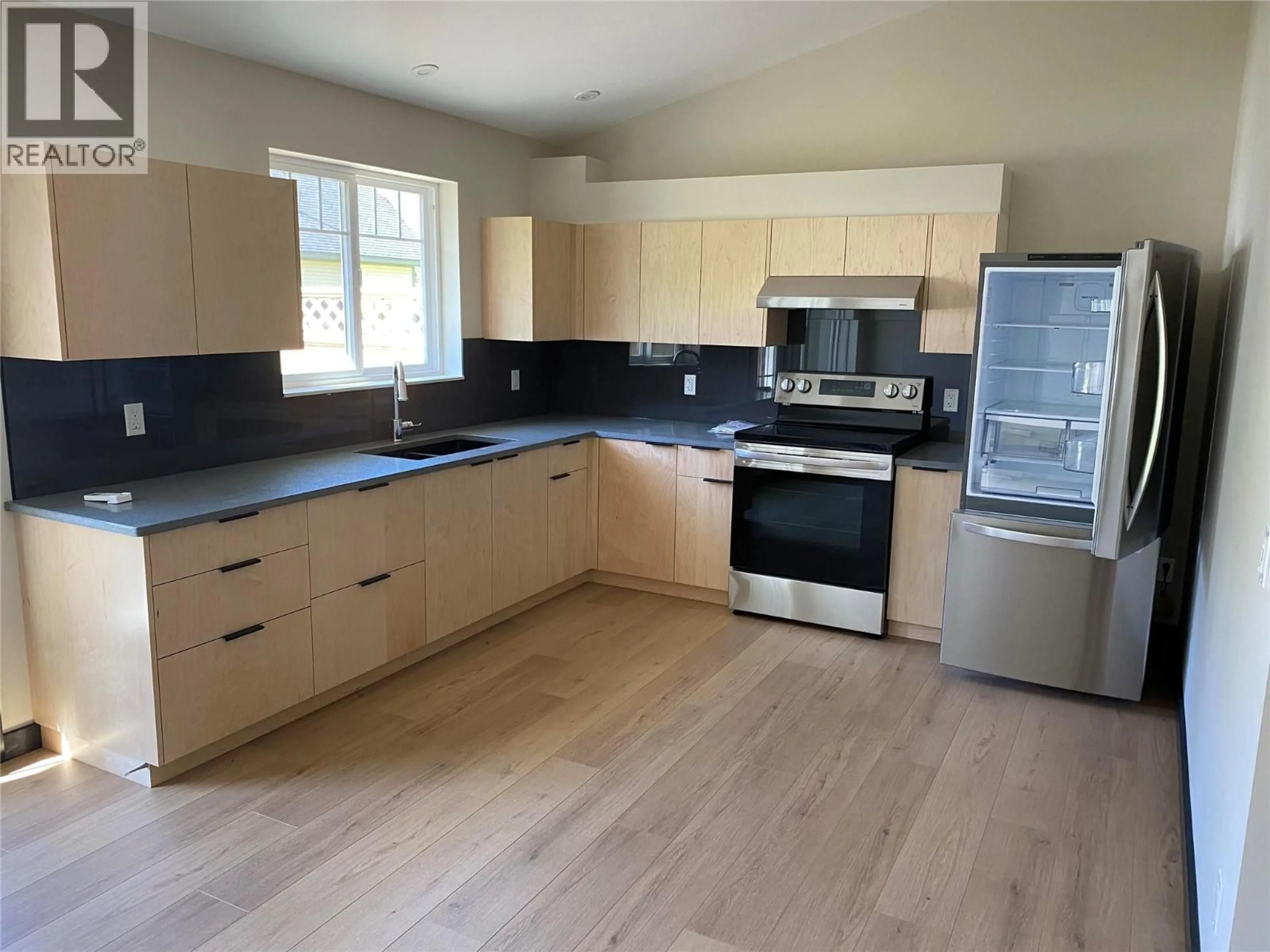 Open concept kitchen, wood/laminate floor for 2 - 611 CASLEY COURT, New Denver British Columbia V0G1S1