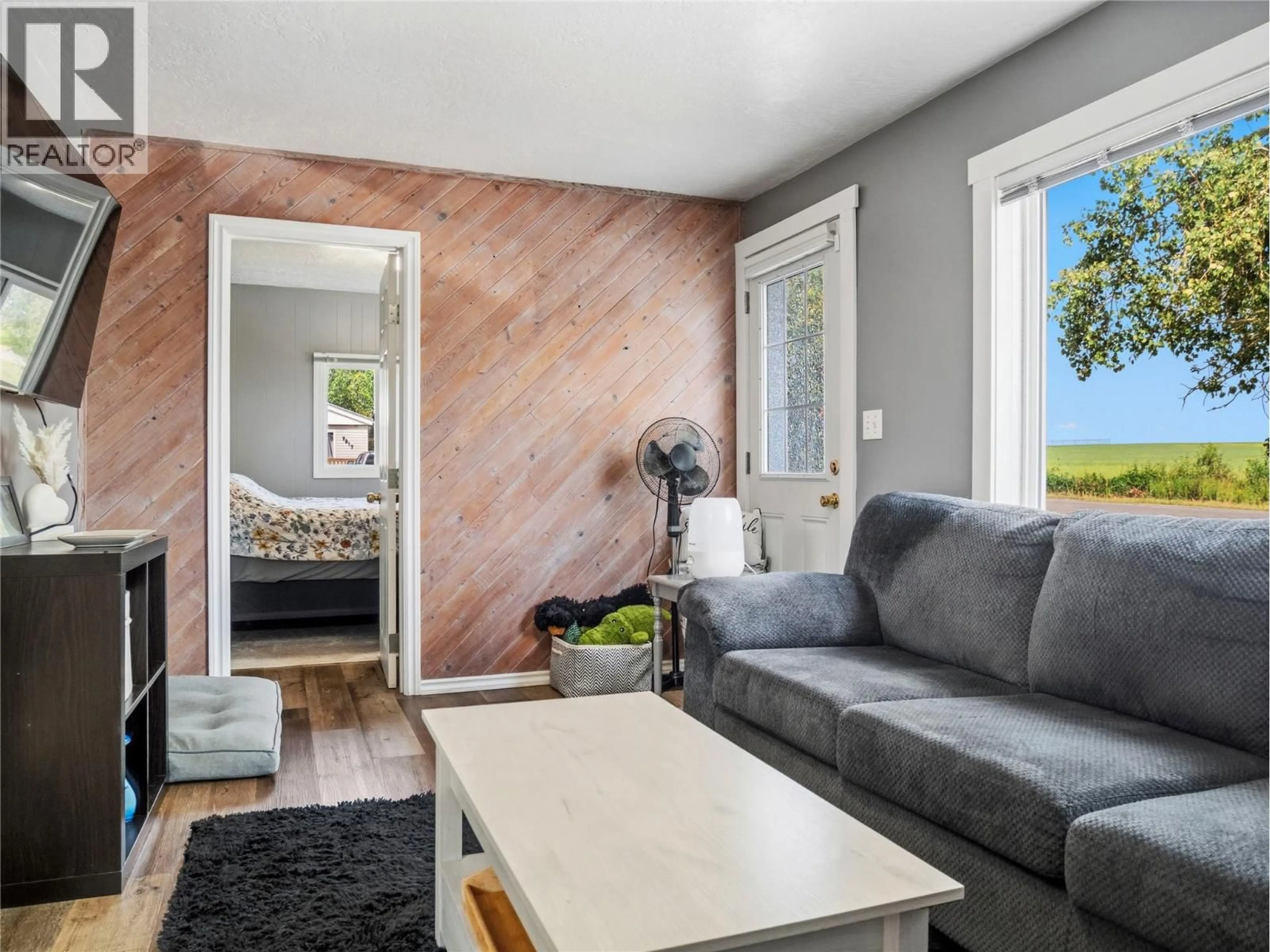 Living room with furniture, wood/laminate floor for 9901 2 STREET, Dawson Creek British Columbia V1G3L1