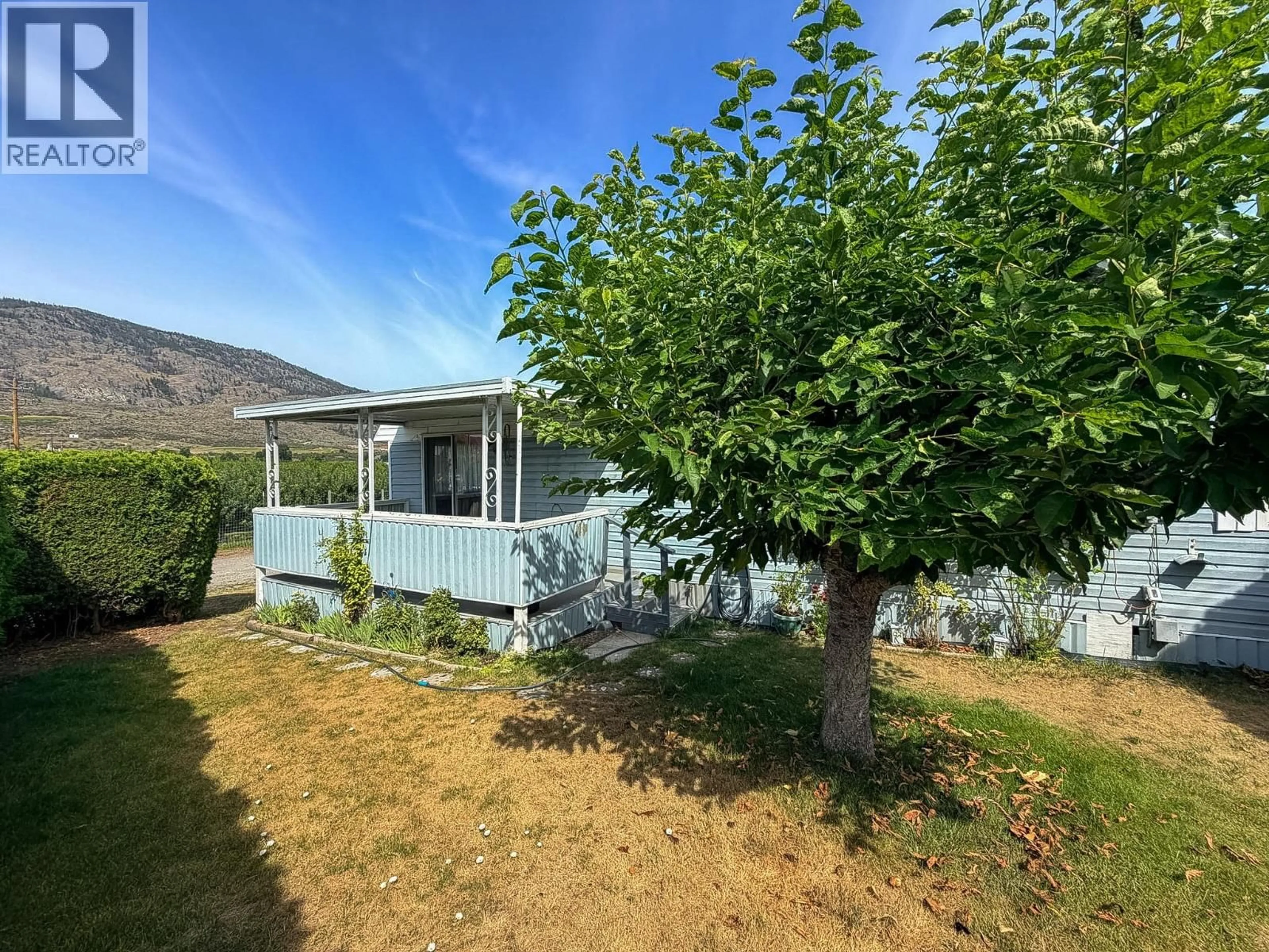 A pic from outside/outdoor area/front of a property/back of a property/a pic from drone, mountain view for 1A - 9904 74TH AVENUE, Osoyoos British Columbia V0H1V5