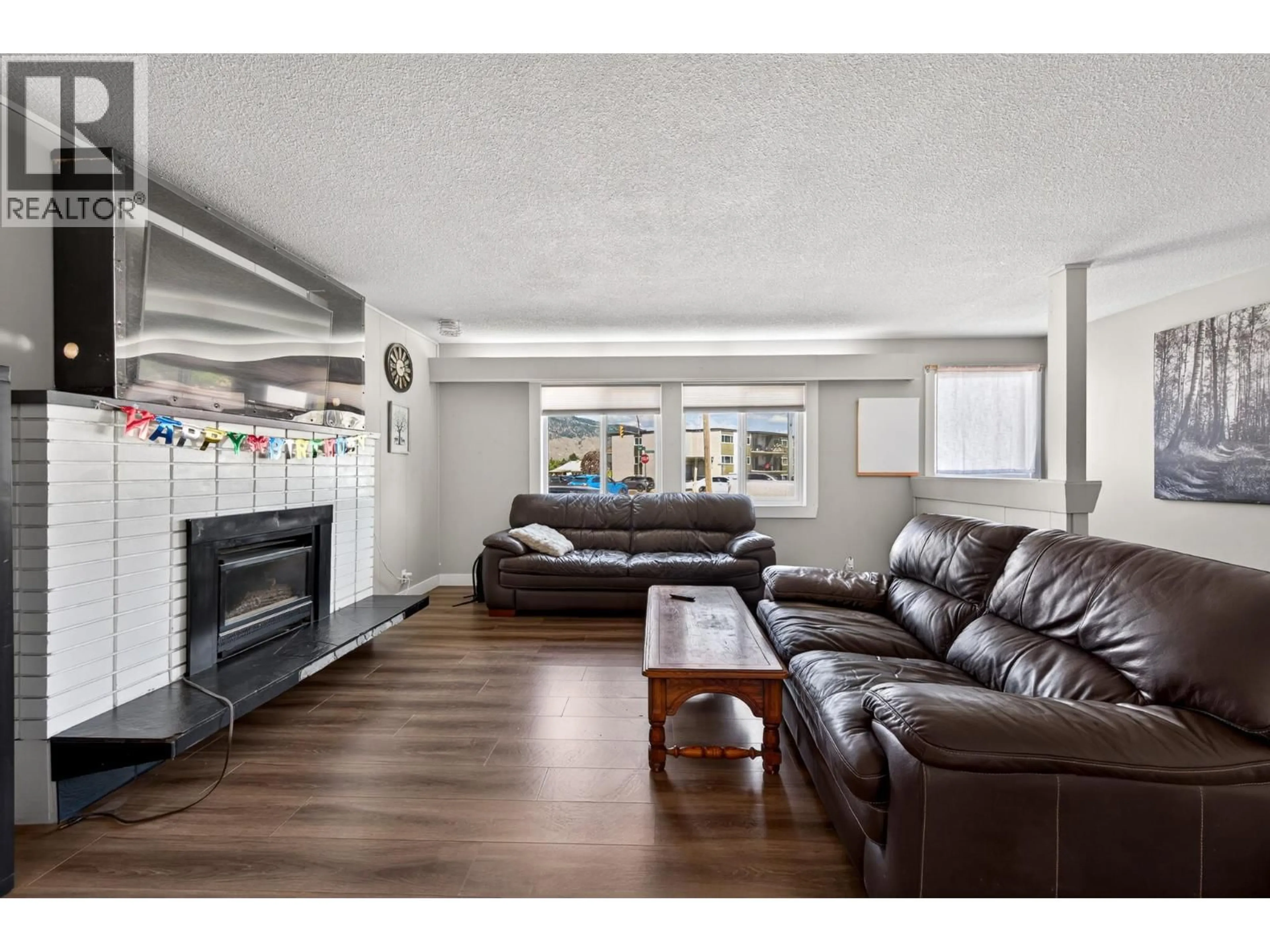 Living room with furniture, wood/laminate floor for 569 FORTUNE DRIVE, Kamloops British Columbia V2B2J8