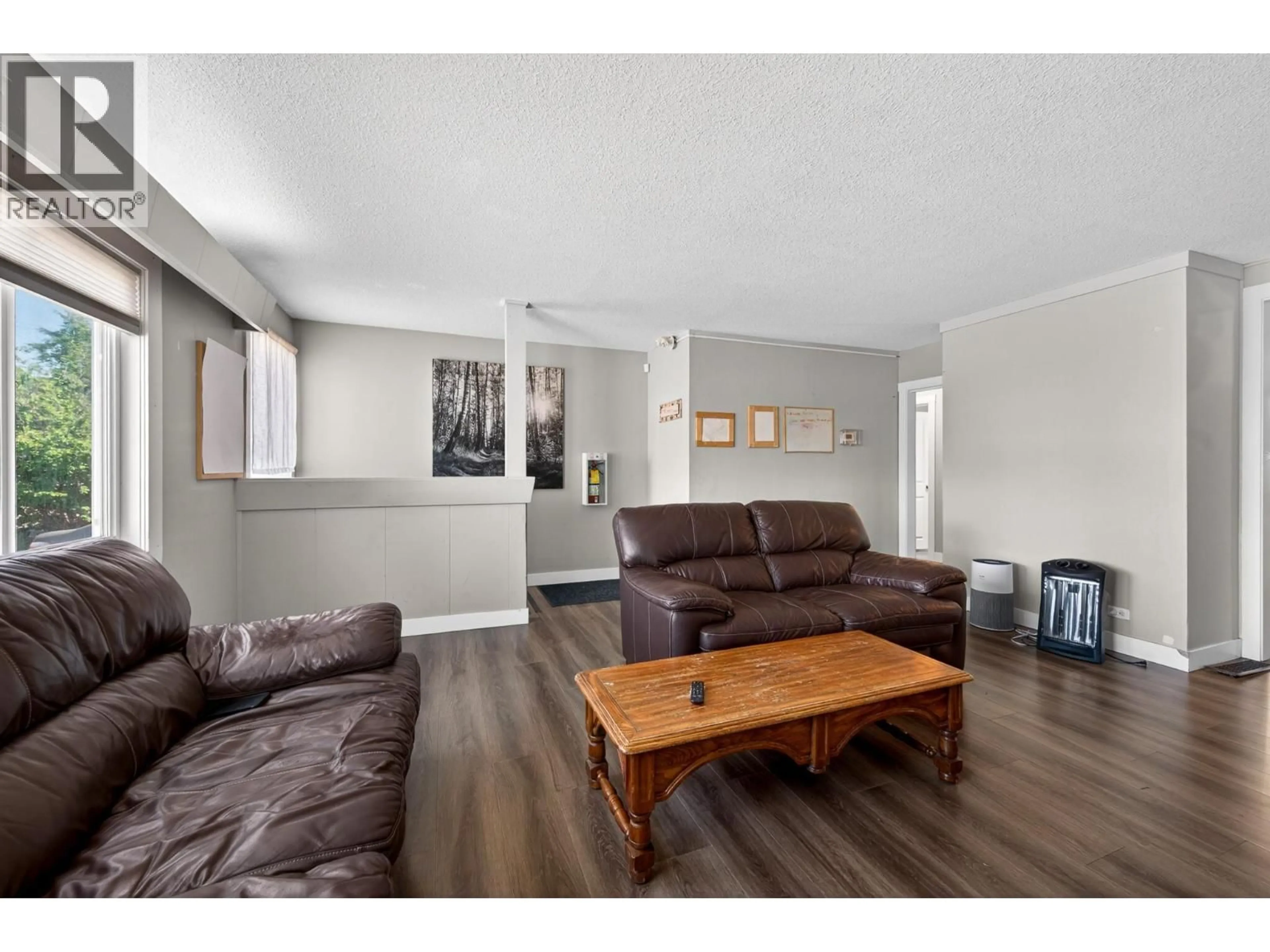 Living room with furniture, wood/laminate floor for 569 FORTUNE DRIVE, Kamloops British Columbia V2B2J8