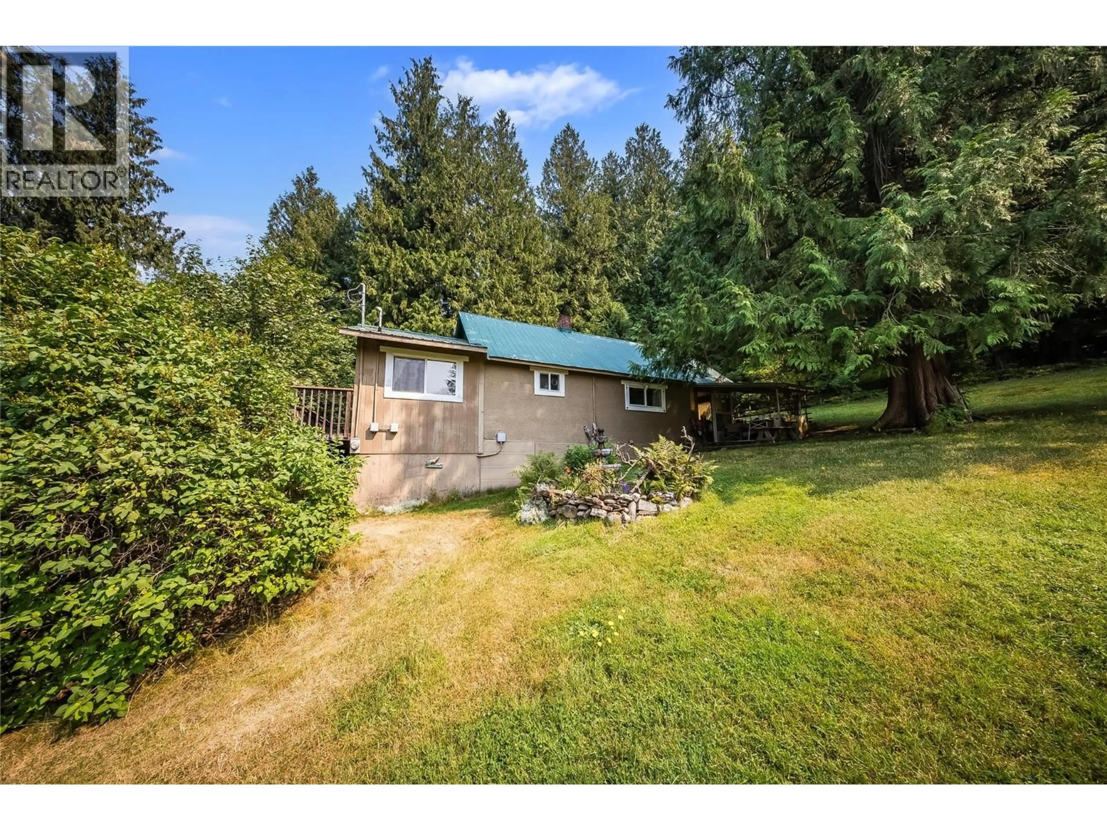A pic from outside/outdoor area/front of a property/back of a property/a pic from drone, forest/trees view for 1562 ARROW LAKES DRIVE, Castlegar British Columbia V1N3N3