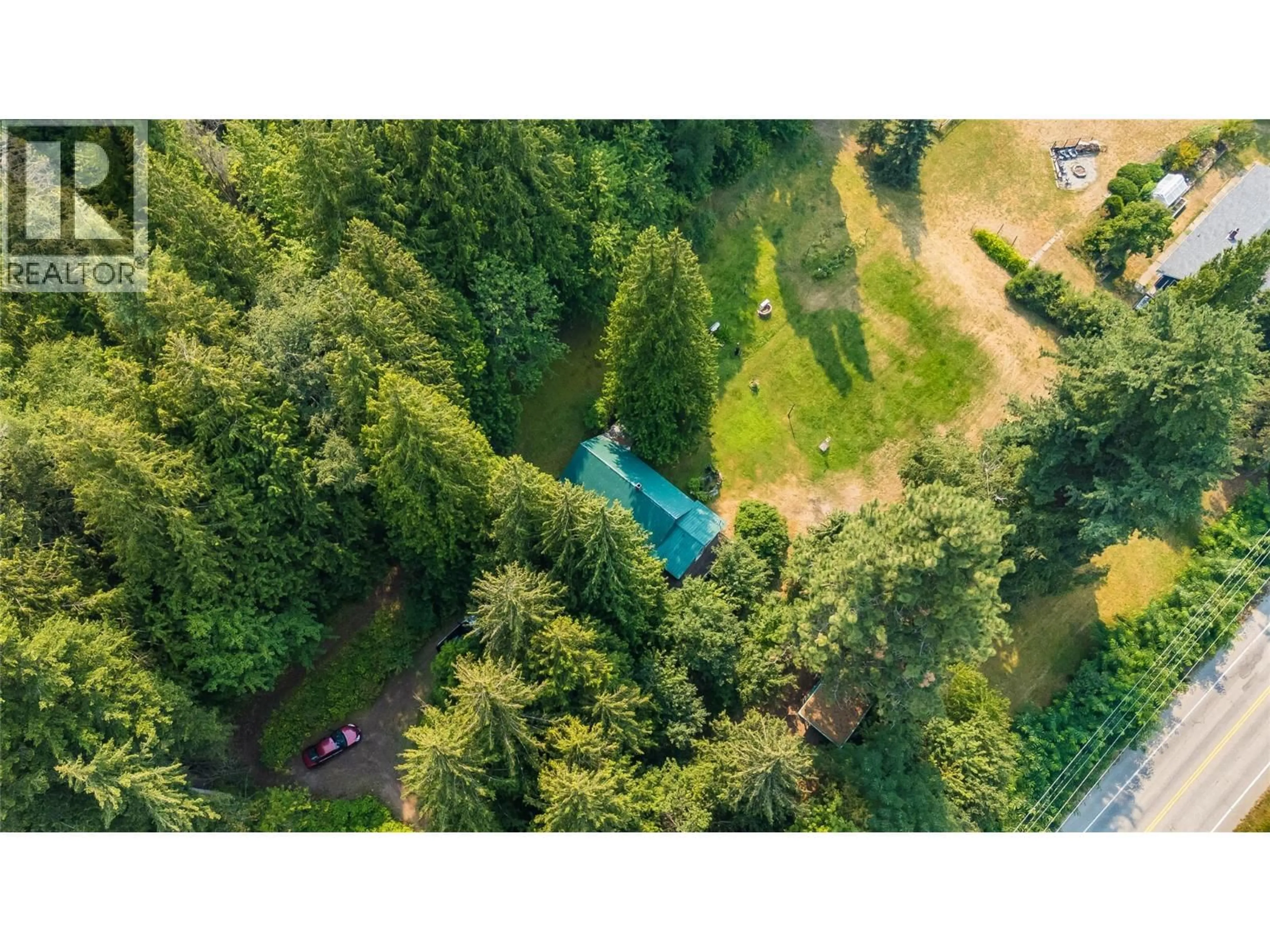 A pic from outside/outdoor area/front of a property/back of a property/a pic from drone, forest/trees view for 1562 ARROW LAKES DRIVE, Castlegar British Columbia V1N3N3
