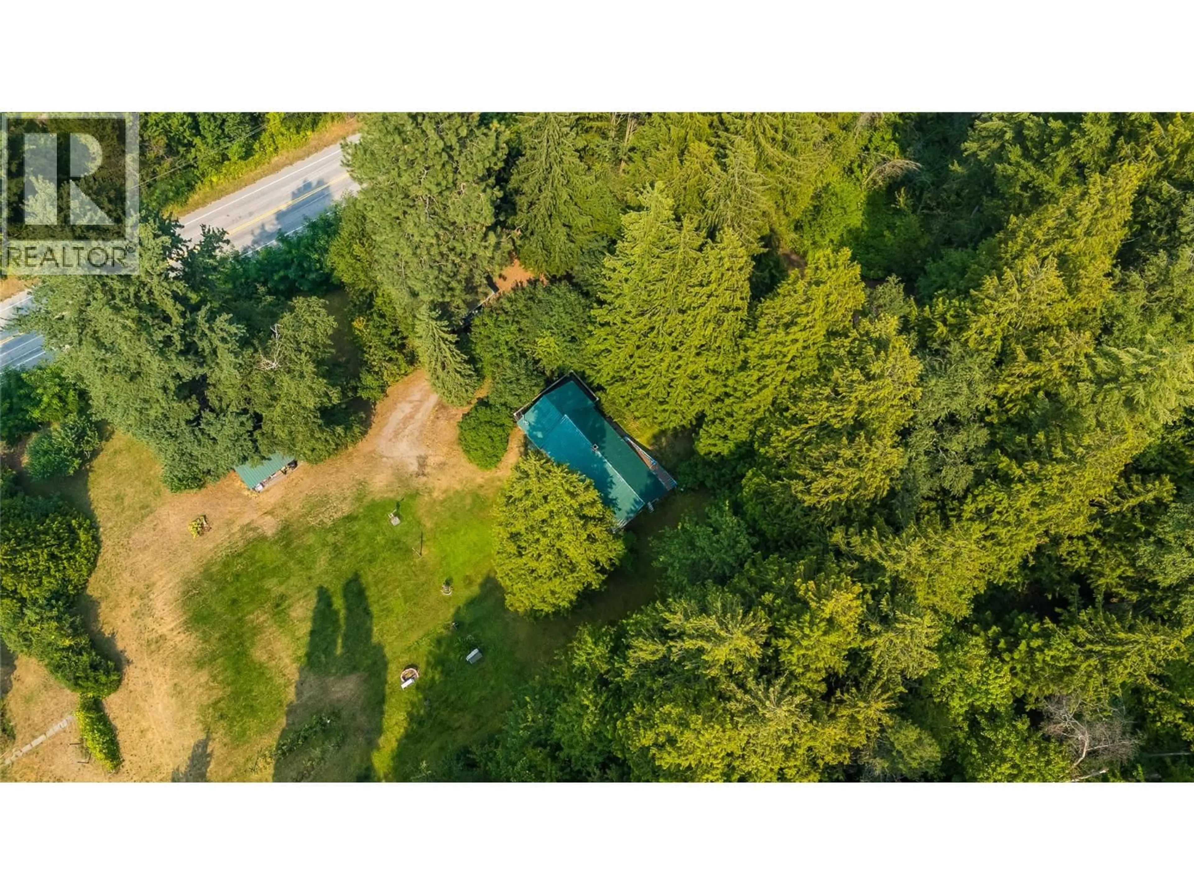 A pic from outside/outdoor area/front of a property/back of a property/a pic from drone, forest/trees view for 1562 ARROW LAKES DRIVE, Castlegar British Columbia V1N3N3