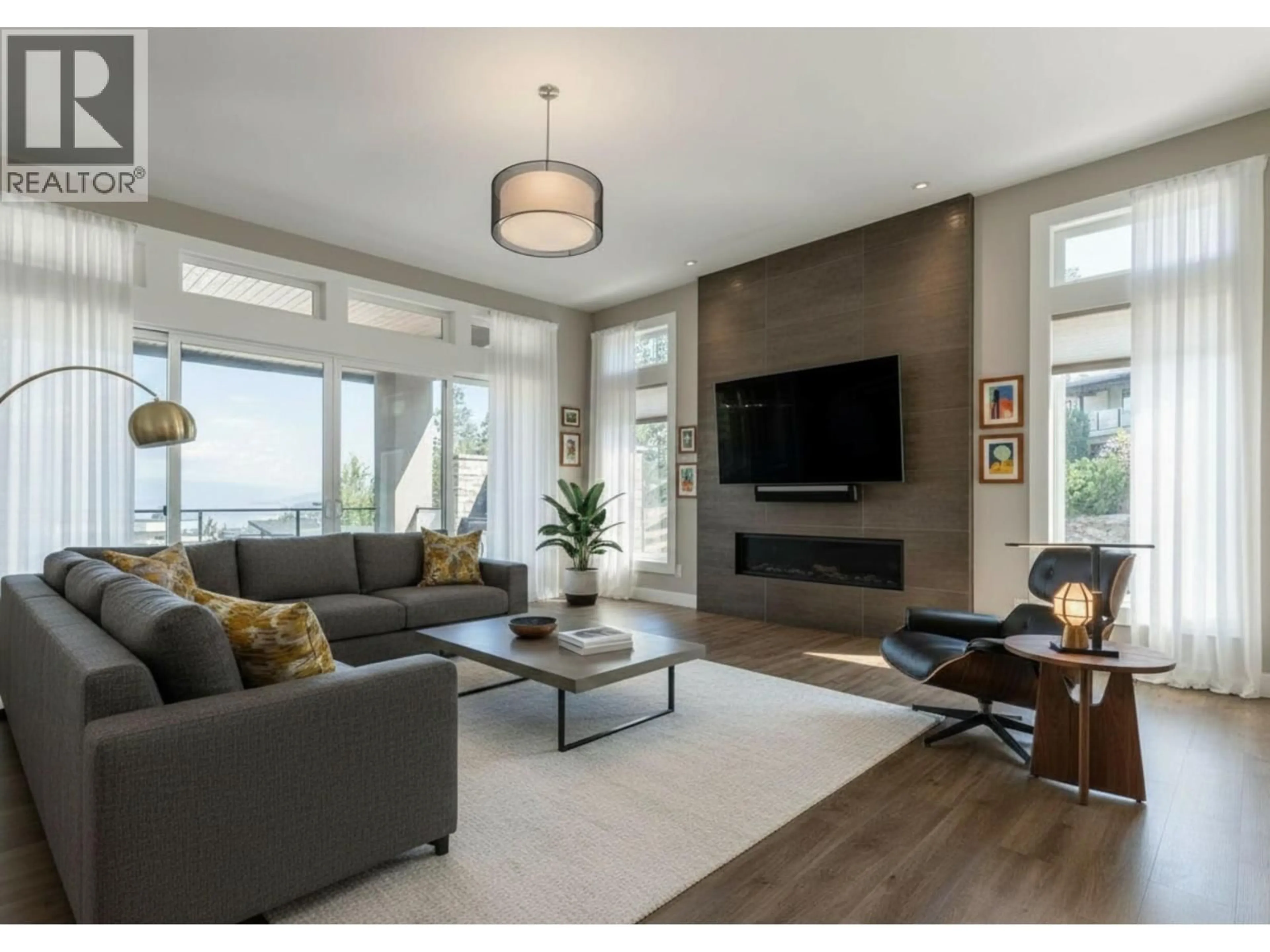 Living room with furniture, wood/laminate floor for 3303 WATER BIRCH CIRCLE, Kelowna British Columbia V1V3G1
