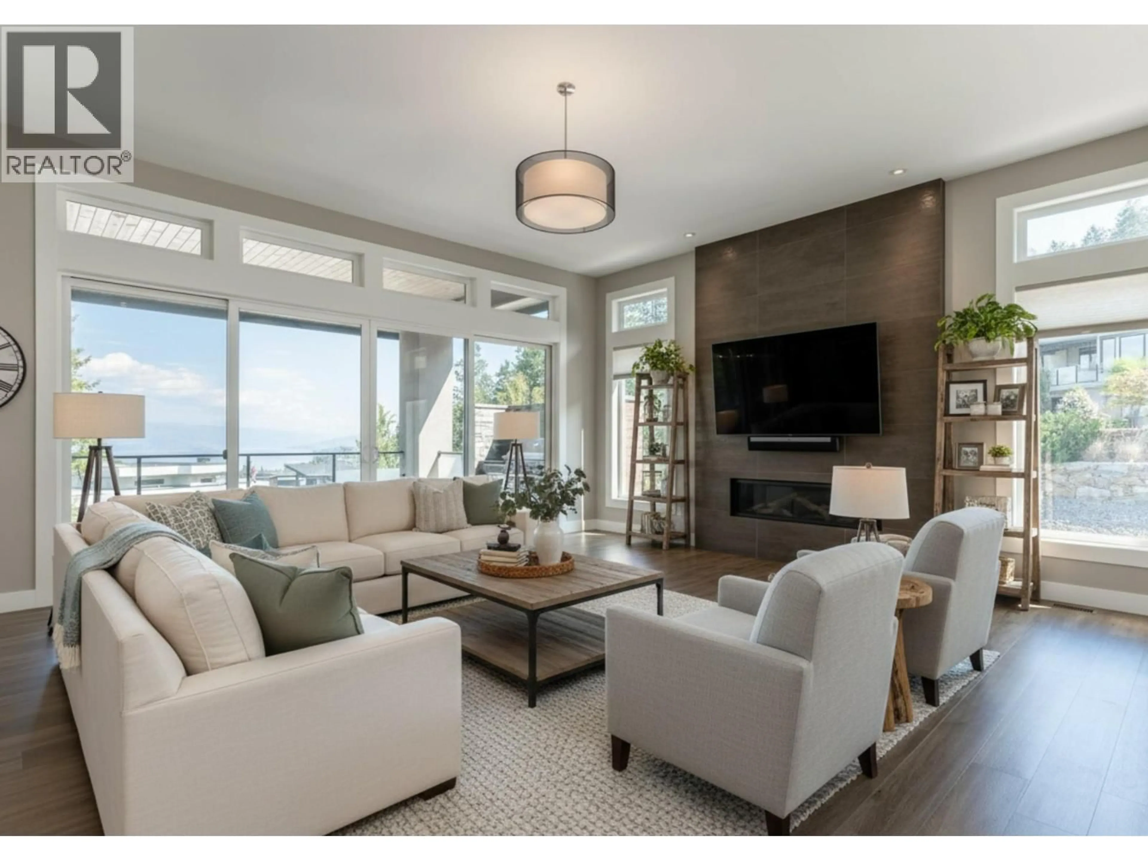 Living room with furniture, wood/laminate floor for 3303 WATER BIRCH CIRCLE, Kelowna British Columbia V1V3G1
