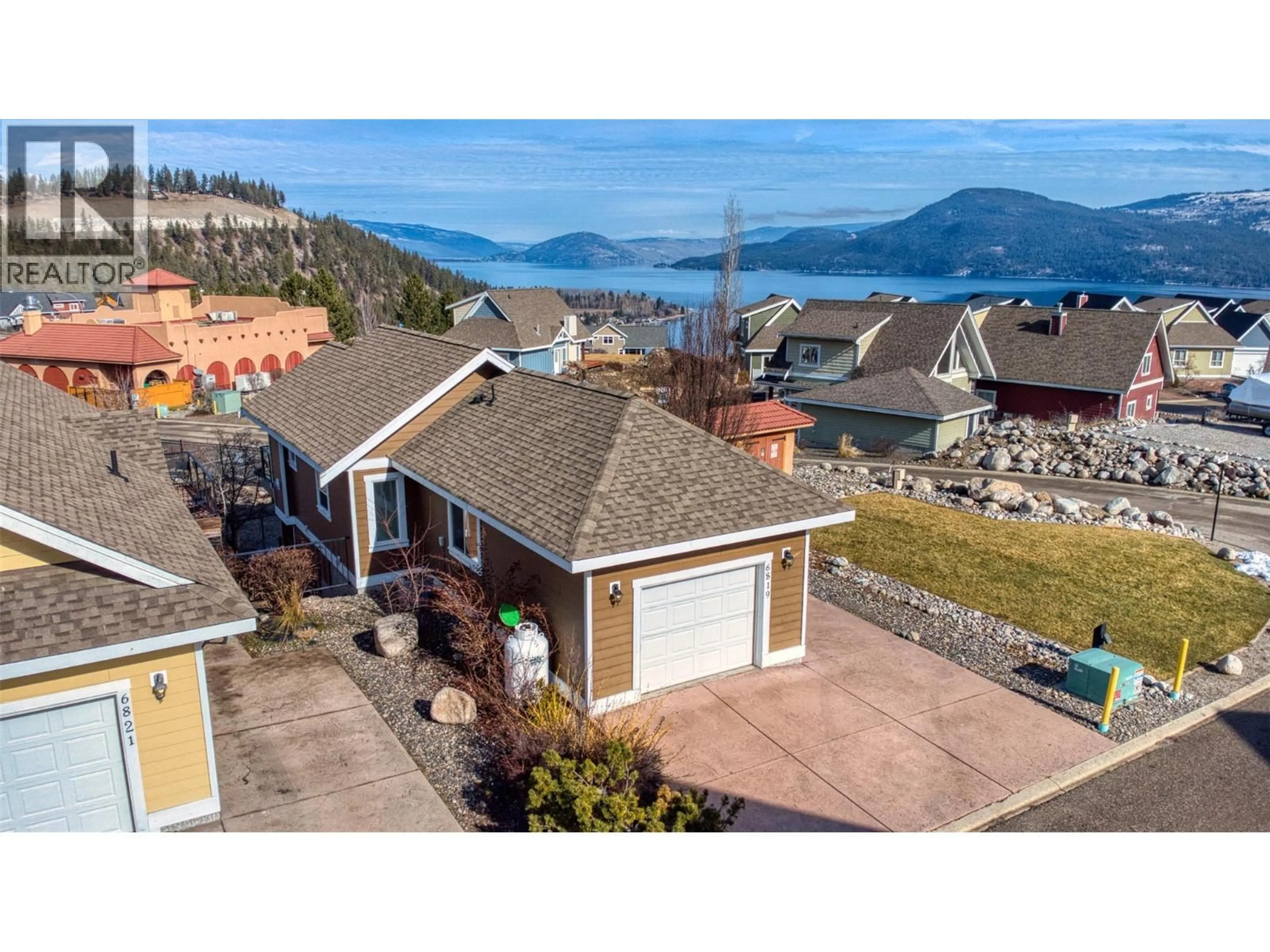 A pic from outside/outdoor area/front of a property/back of a property/a pic from drone, water/lake/river/ocean view for 355 - 6819 MADRID WAY, Kelowna British Columbia V1Z3R8