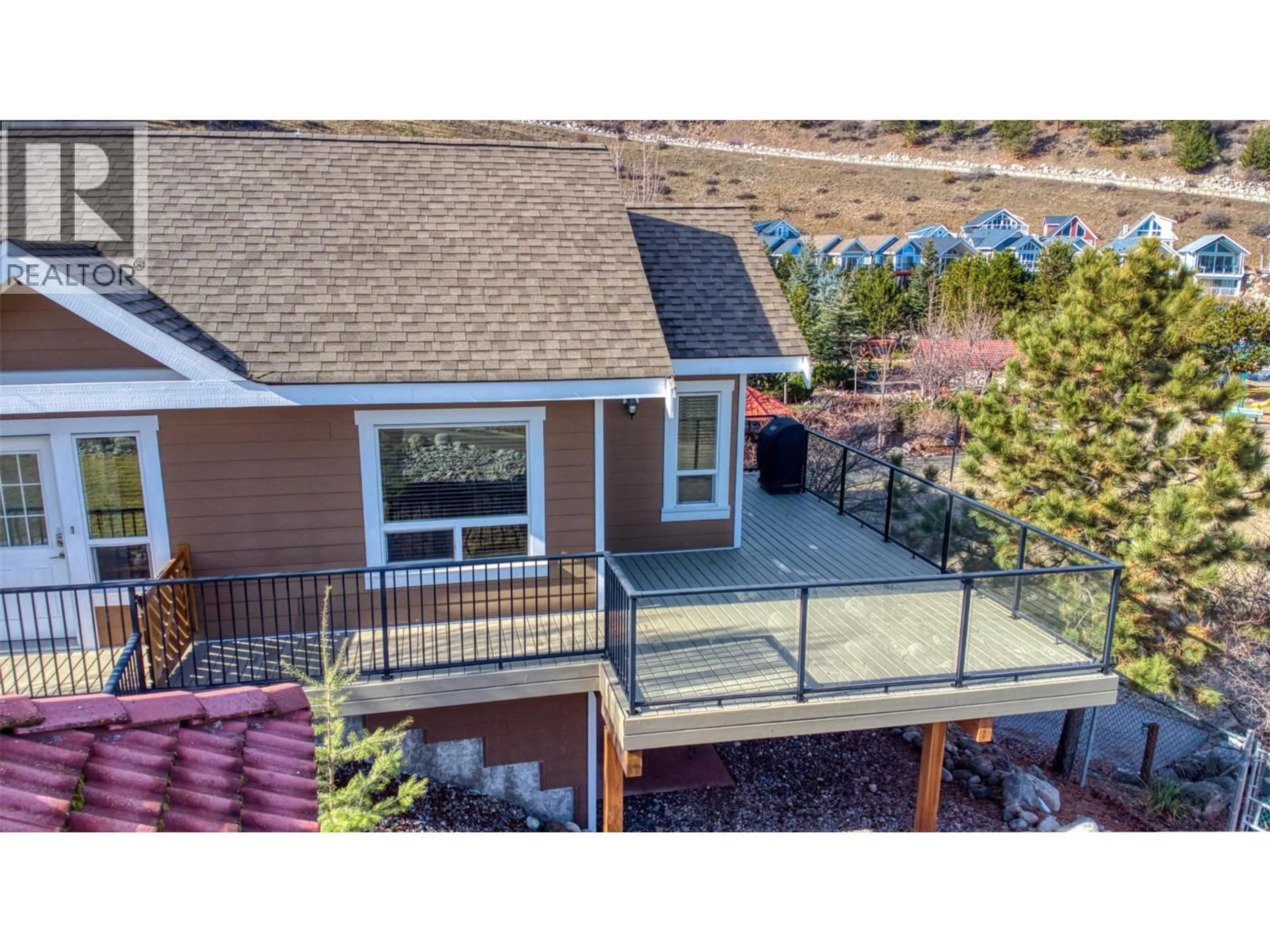 A pic from outside/outdoor area/front of a property/back of a property/a pic from drone, mountain view for 355 - 6819 MADRID WAY, Kelowna British Columbia V1Z3R8