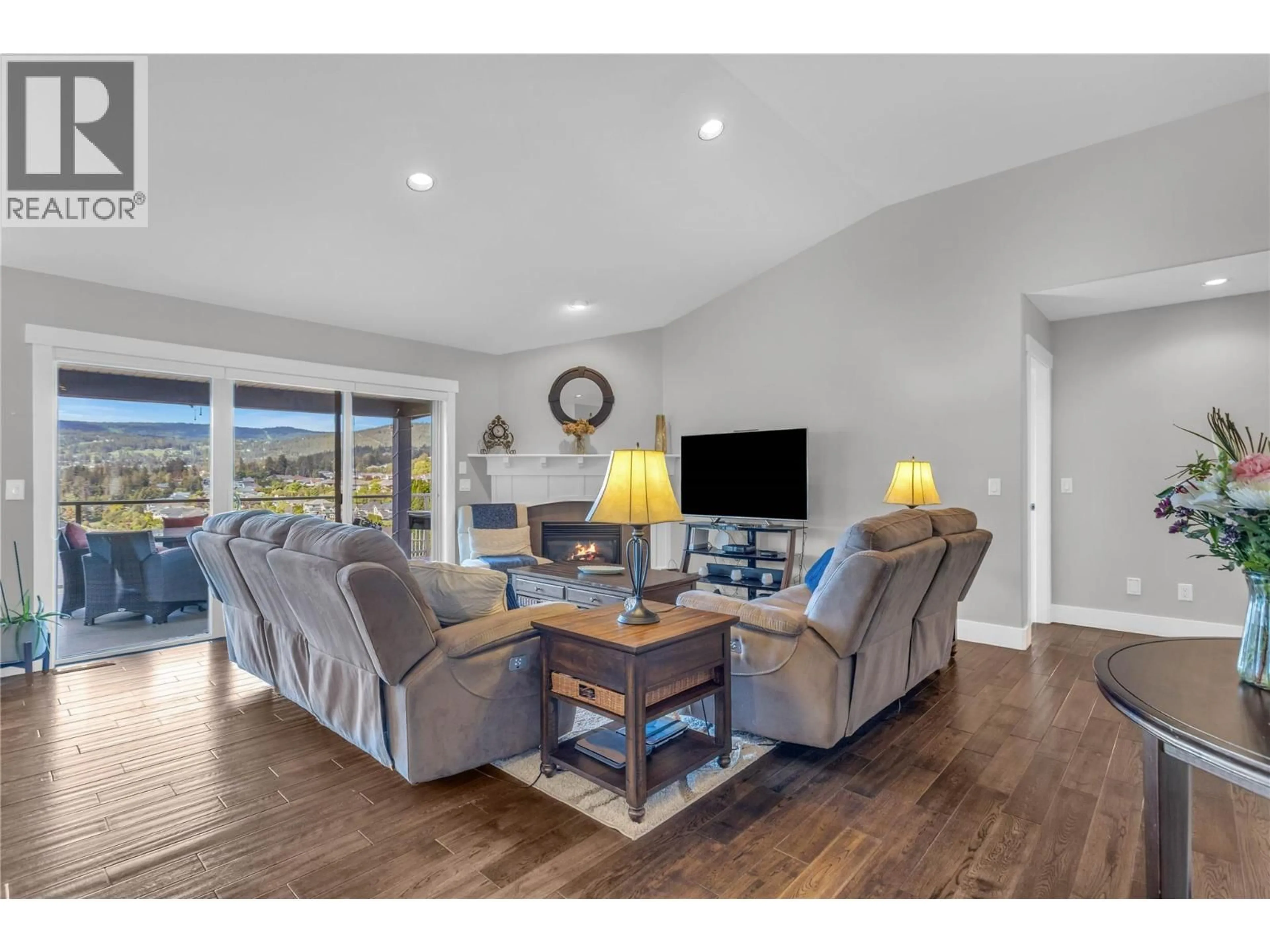Living room with furniture, wood/laminate floor for 2493 IRONRIDGE ROAD, West Kelowna British Columbia V4T2Y4