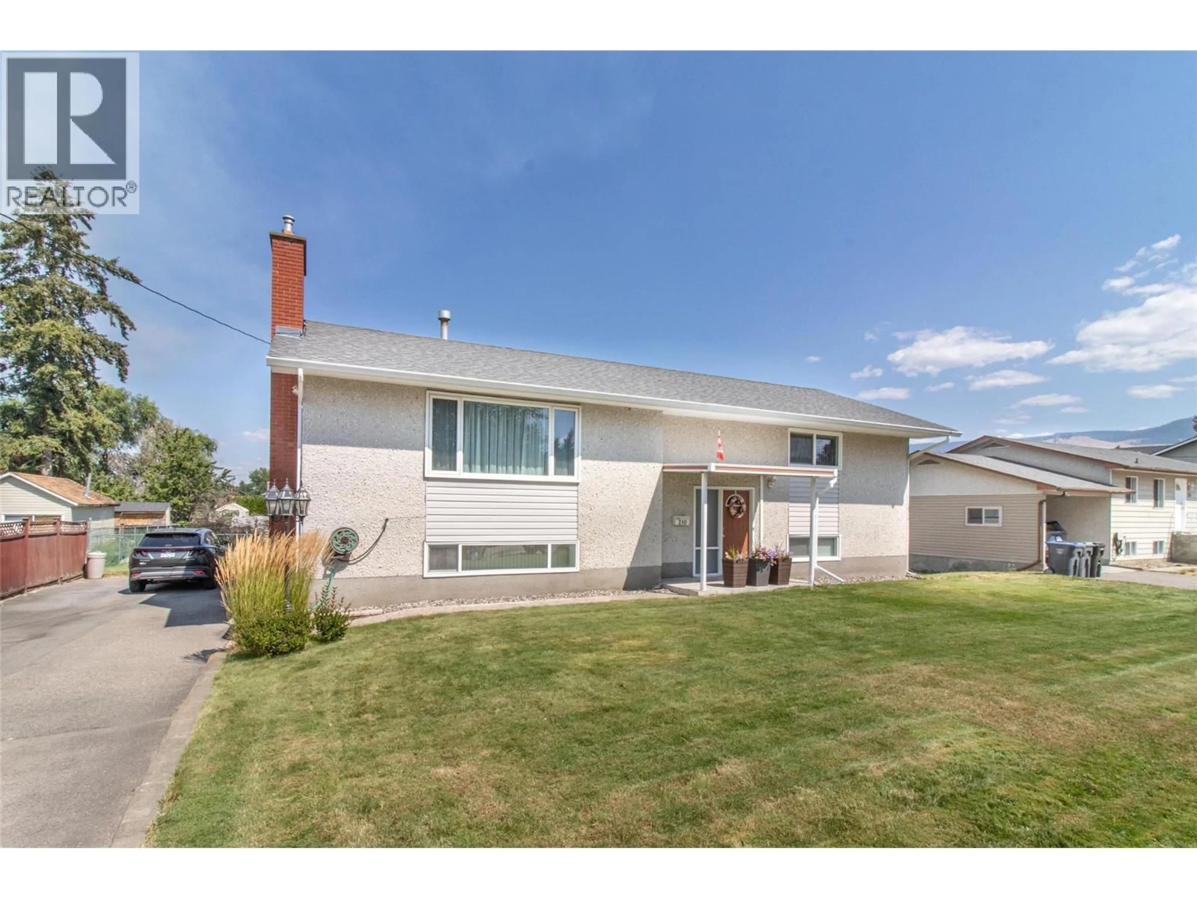 Home with vinyl exterior material, street for 210 WALLACE ROAD, Kelowna British Columbia V1X4T1
