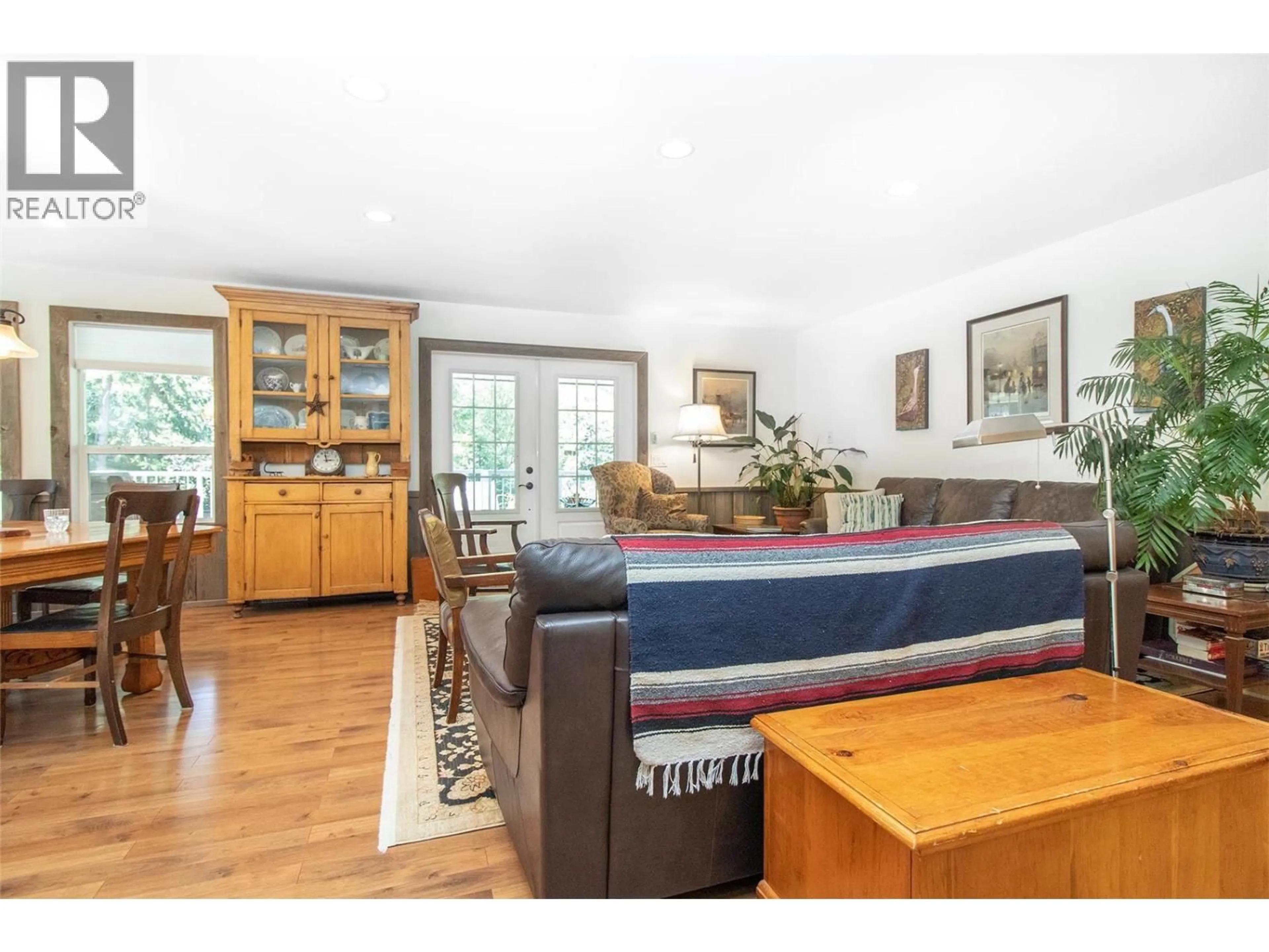 Living room with furniture, wood/laminate floor for 2508 HARVARD ROAD, Kelowna British Columbia V1W4C2