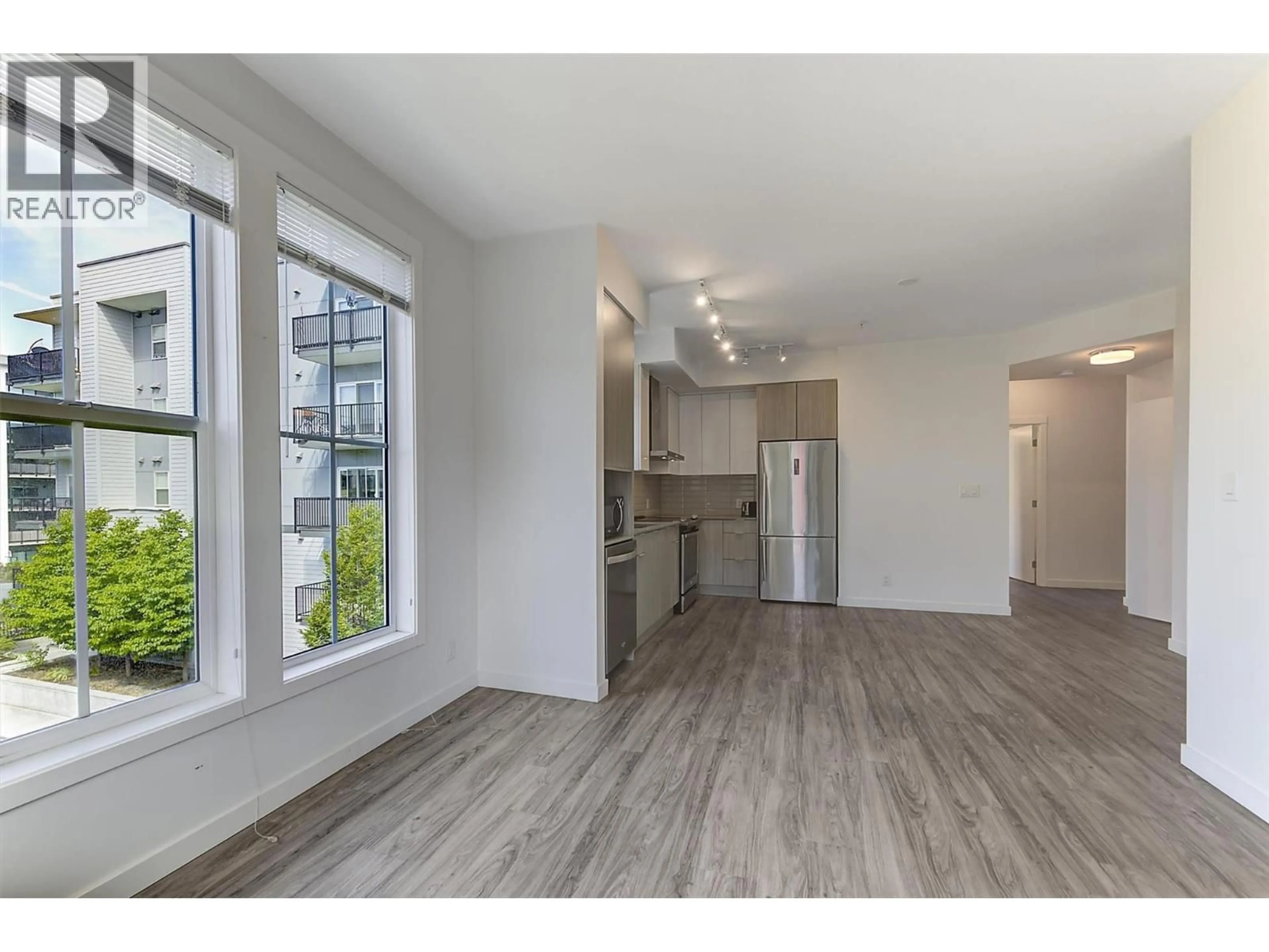 Open concept kitchen, wood/laminate floor for 306 - 1775 CHAPMAN PLACE, Kelowna British Columbia V1Y0G3